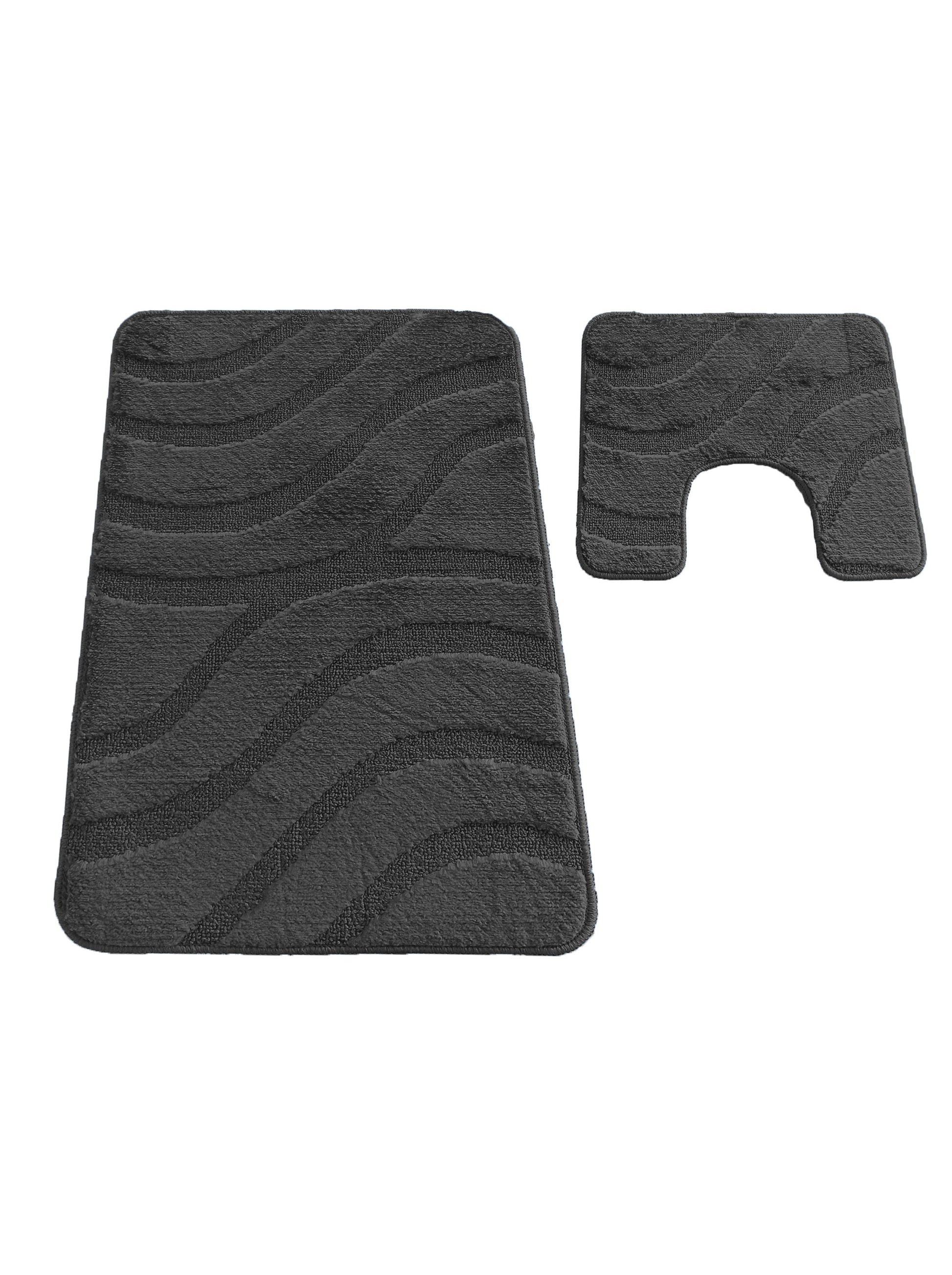 Deux tapis en textile anthracite, l'un rectangulaire et l'autre en forme de U, avec des motifs de vagues en relief