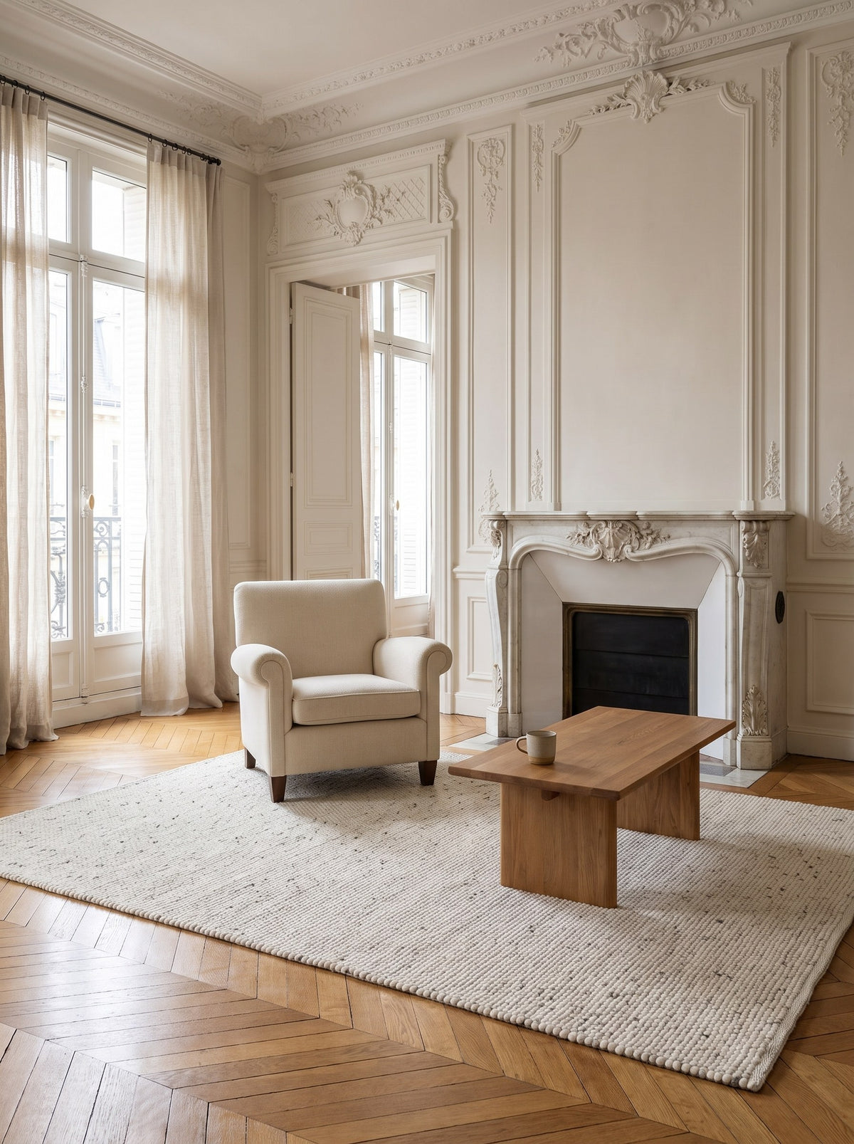 Ecru 100% Wool Rug - Grezzo at the centre of the living room in a Haussmann flat in Paris, on chevron parquet