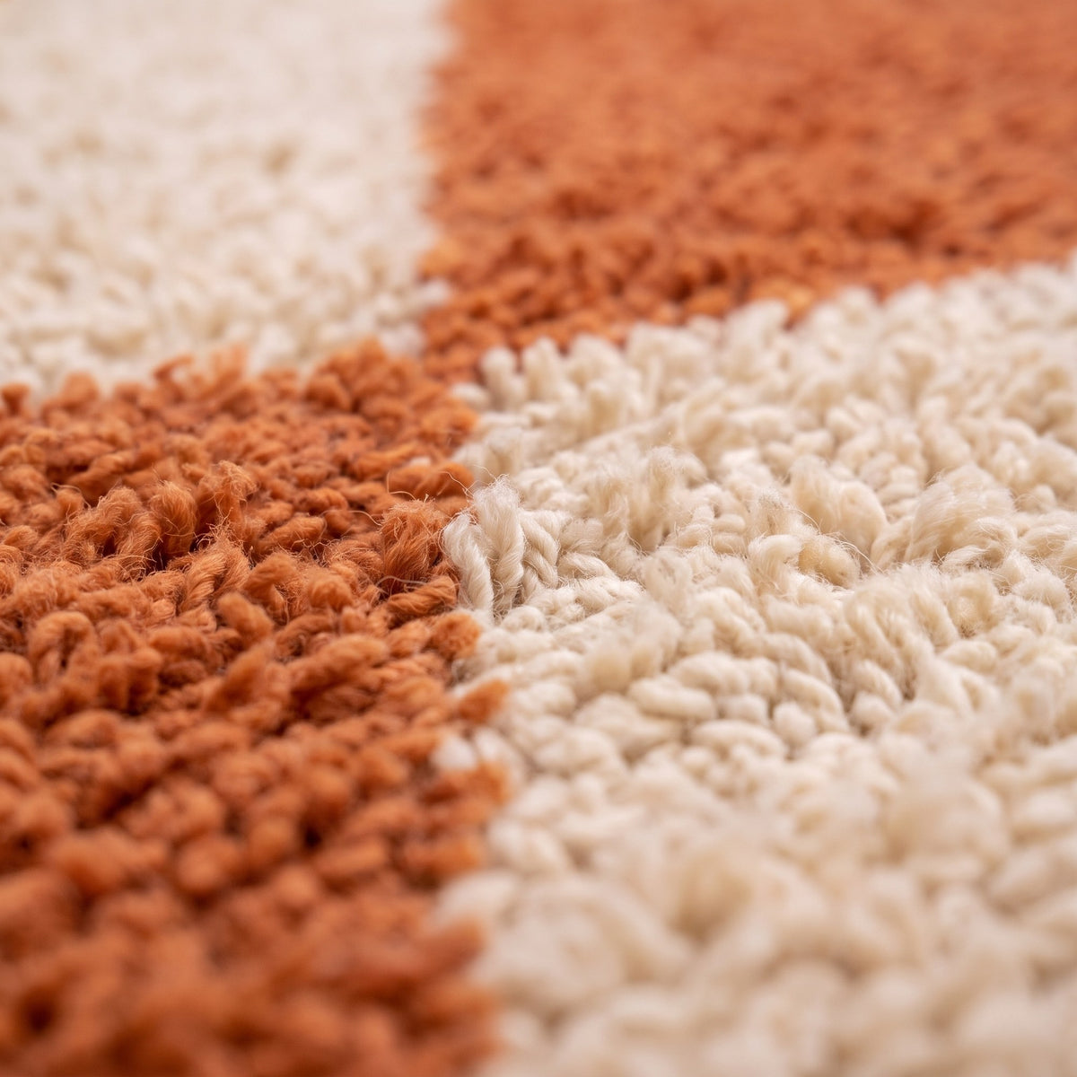 Close-up of a motif on the Tafraout Berber rug, plain terracotta field, four large solid ecru diamonds