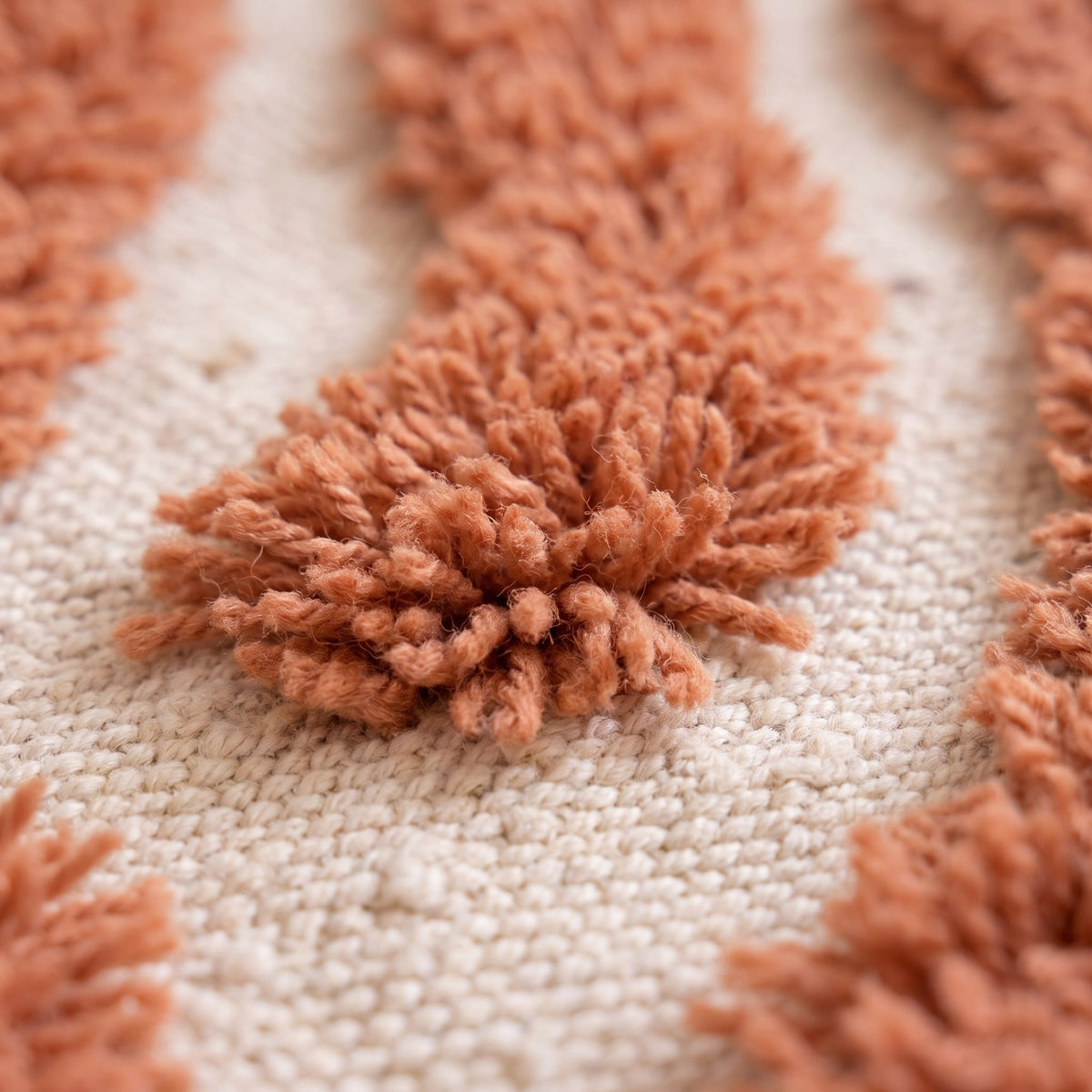 Close-up of a motif on the Anmira Berber rug, short-woven ecru base, large leaf