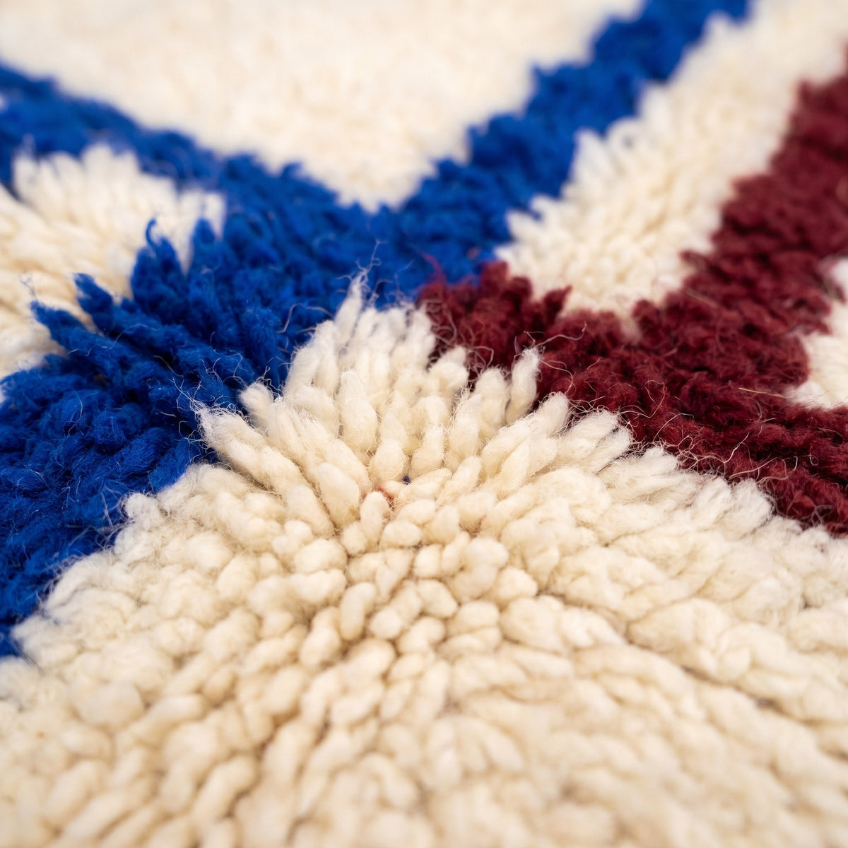 Close-up of a motif on the Zilmar Berber rug, ecru long-pile ground, seven blue bands