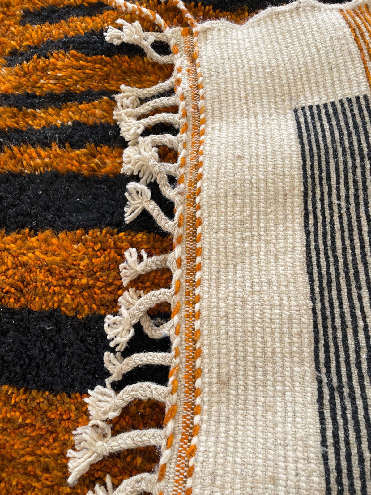 Close-up of the back of the Boudinar Berber rug, knots visible on the cotton warp, no backing