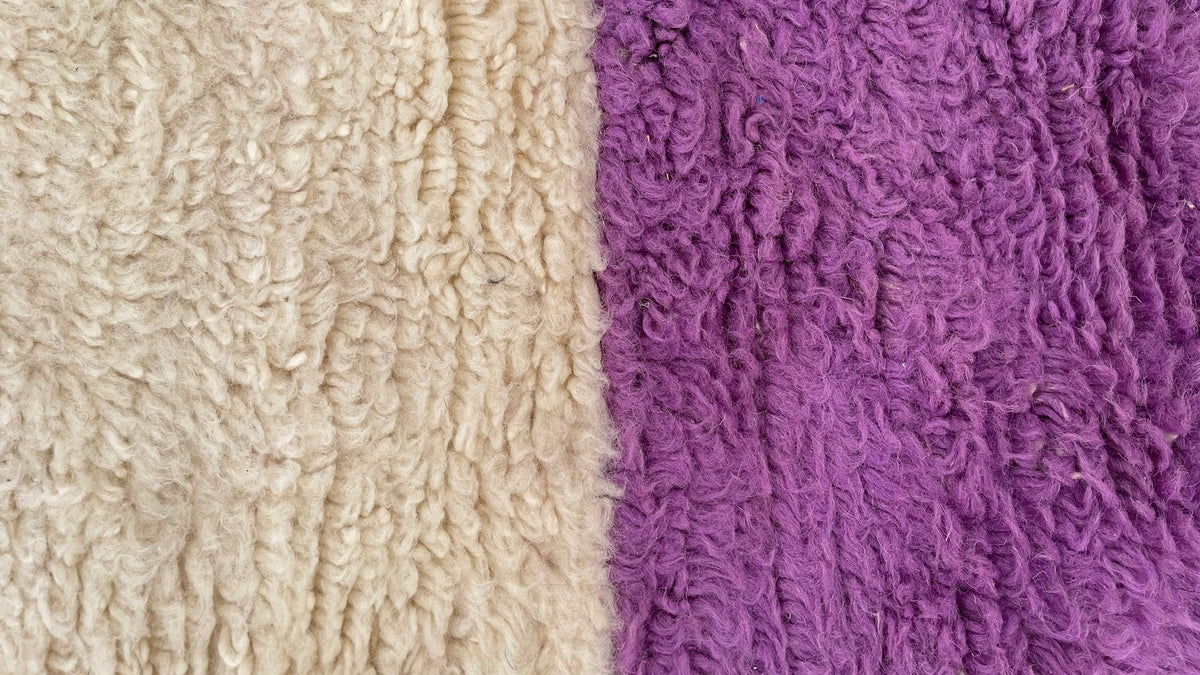 Gros plan sur la laine du tapis berbère Tahala, poil blanc et jaune noué à la main