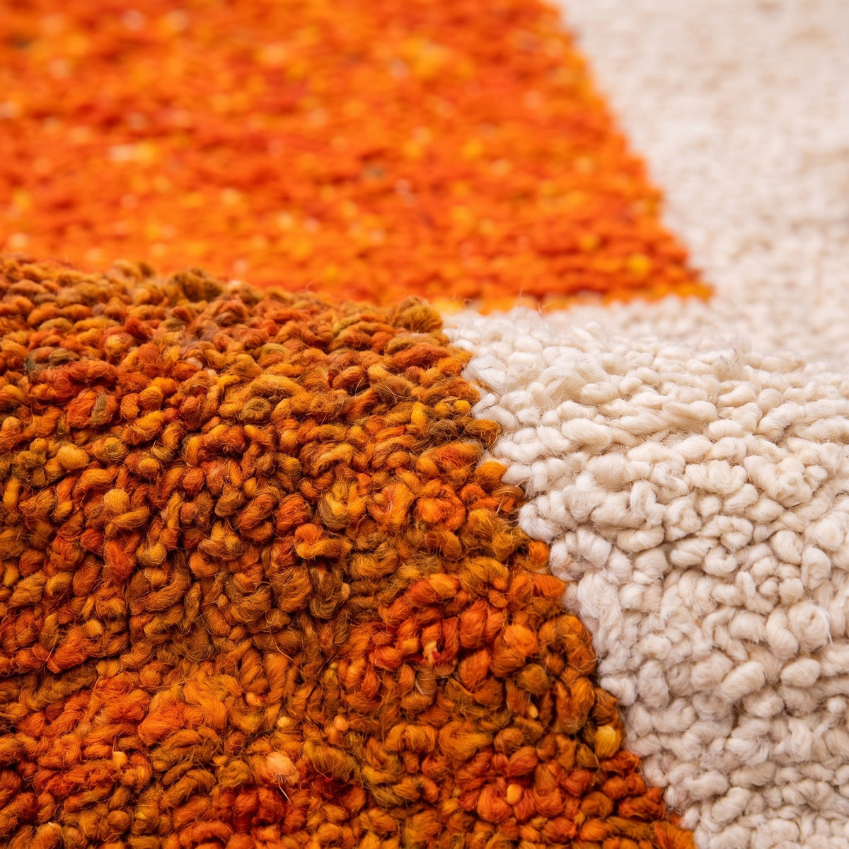 Close-up of a motif on the Amadal Berber rug, three stacked bright orange blocks on the left