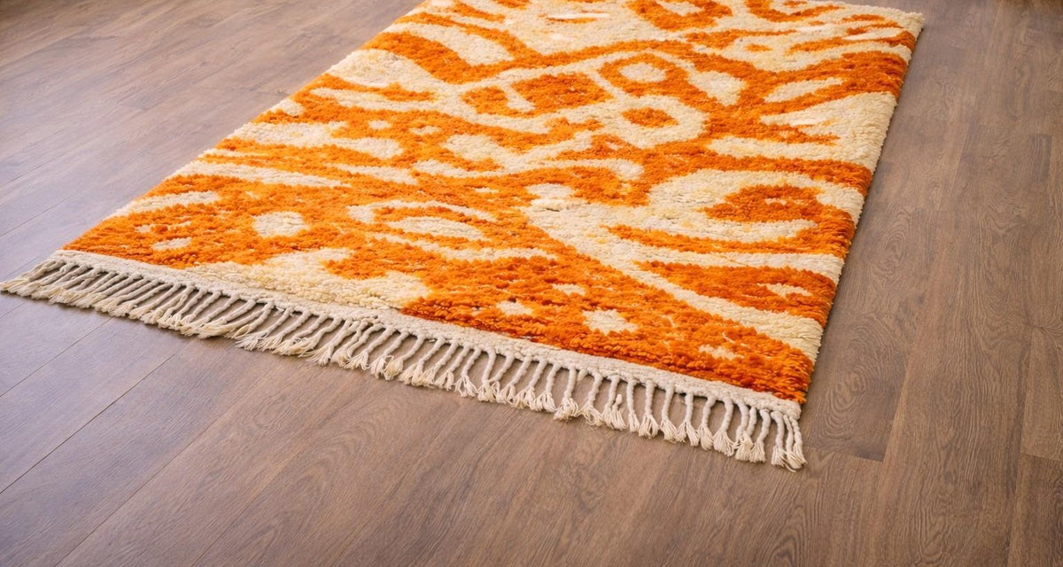 Todgha colourful Berber rug in orange and white, on the floor, seen from the side, hand-knotted in Morocco