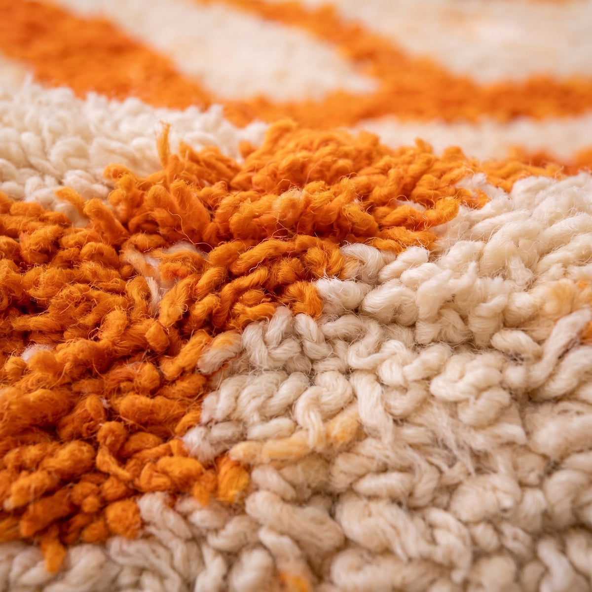 Close-up of a motif on the Todgha Berber rug, bright orange ground with a long pile