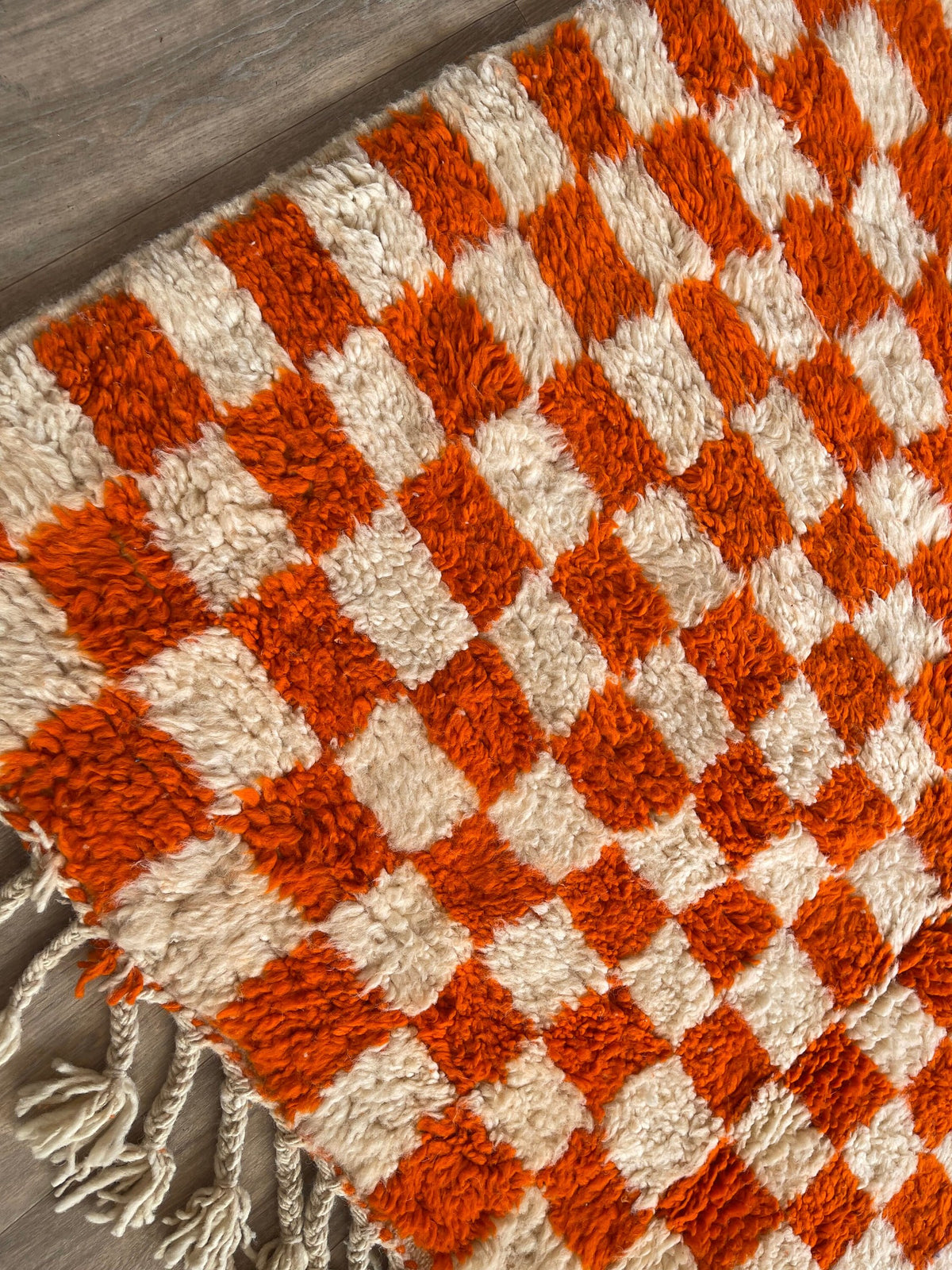 Close-up of the fringes on the Ouzina Berber rug, braided, ecru, knotted by hand