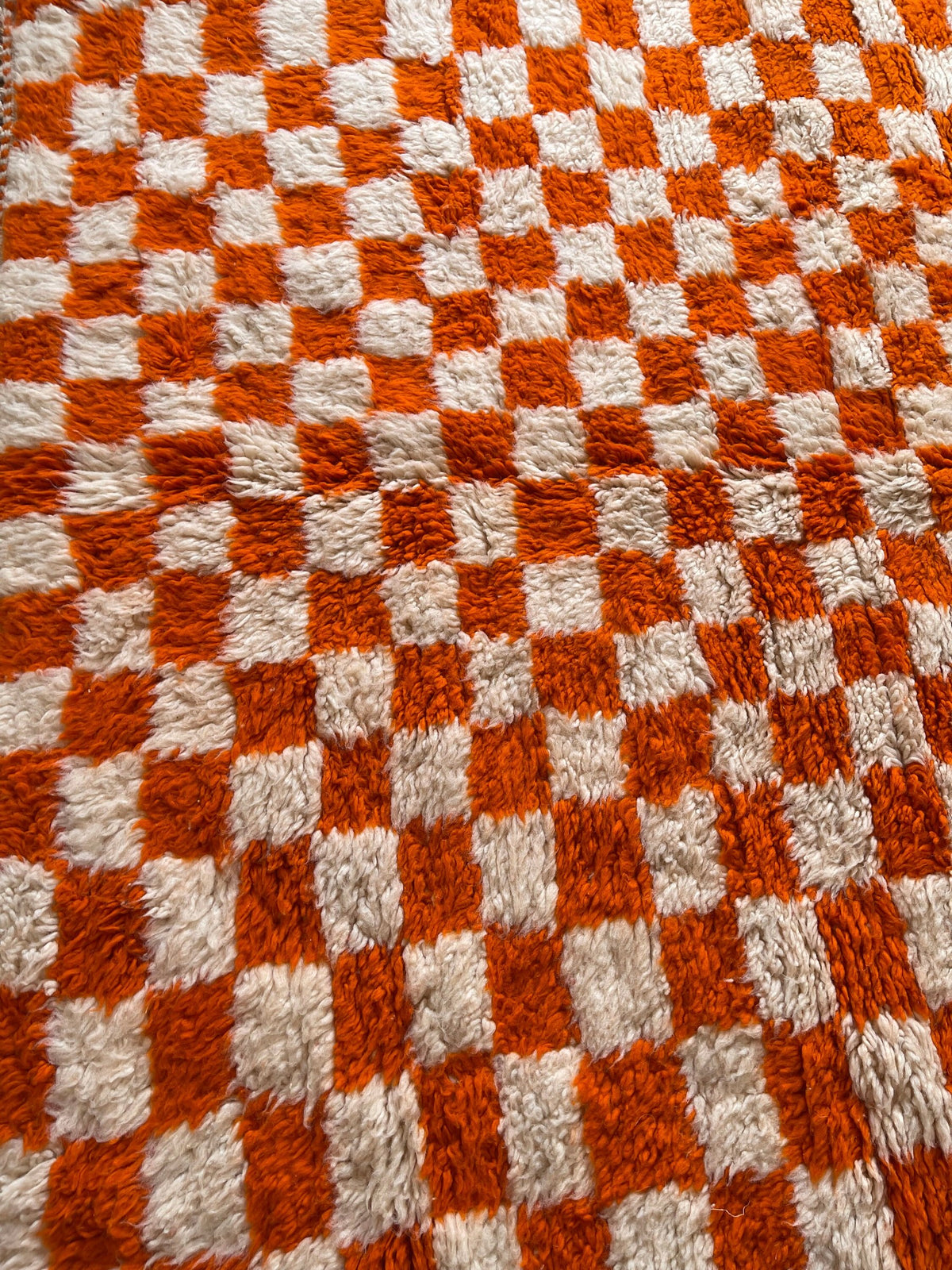 Close-up of the wool of the Ouzina Berber rug, long-pile sheep's wool, orange