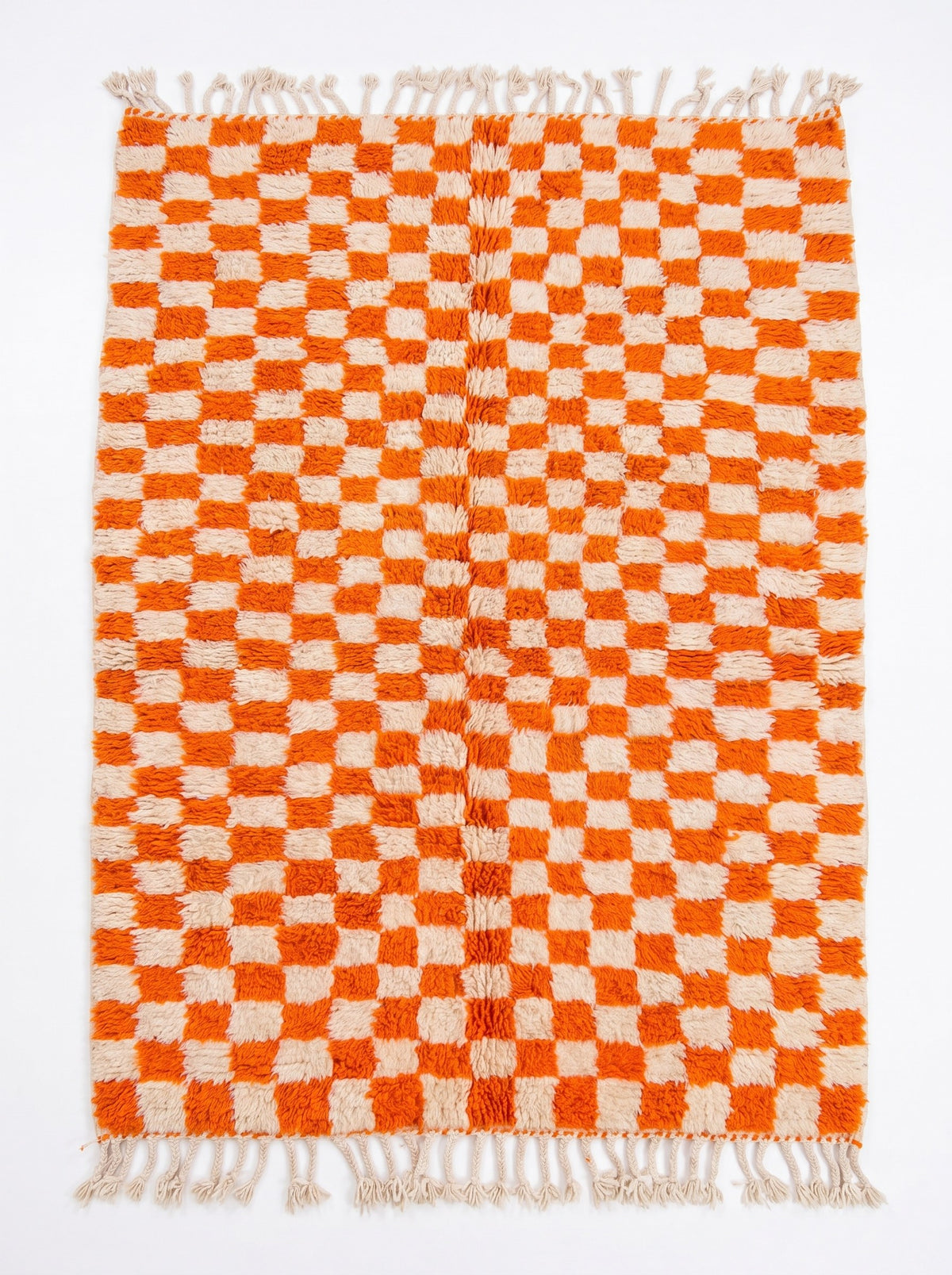Ouzina orange checkerboard Berber rug, laid flat, all-over even checkerboard in bright orange and ecru, braided ecru fringes