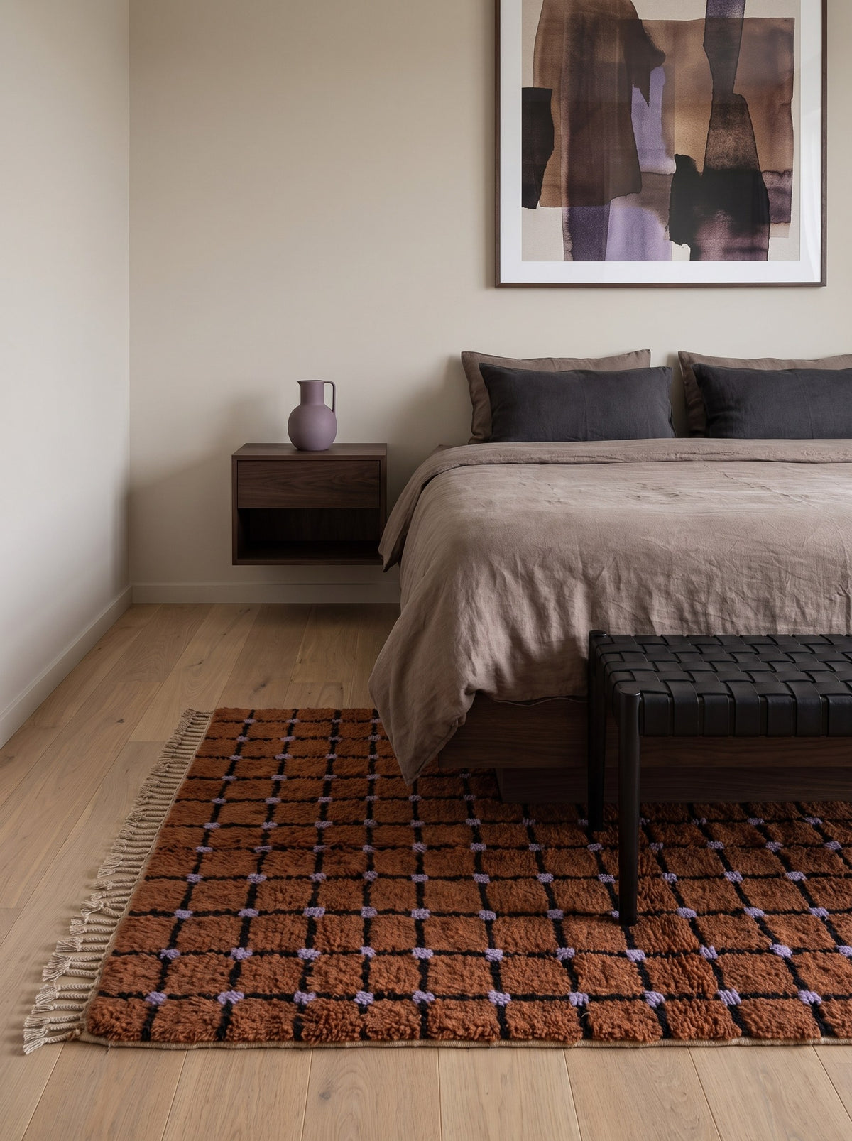 Terracotta checkerboard Tirfalt Berber rug in a bedroom, hand-knotted in Morocco