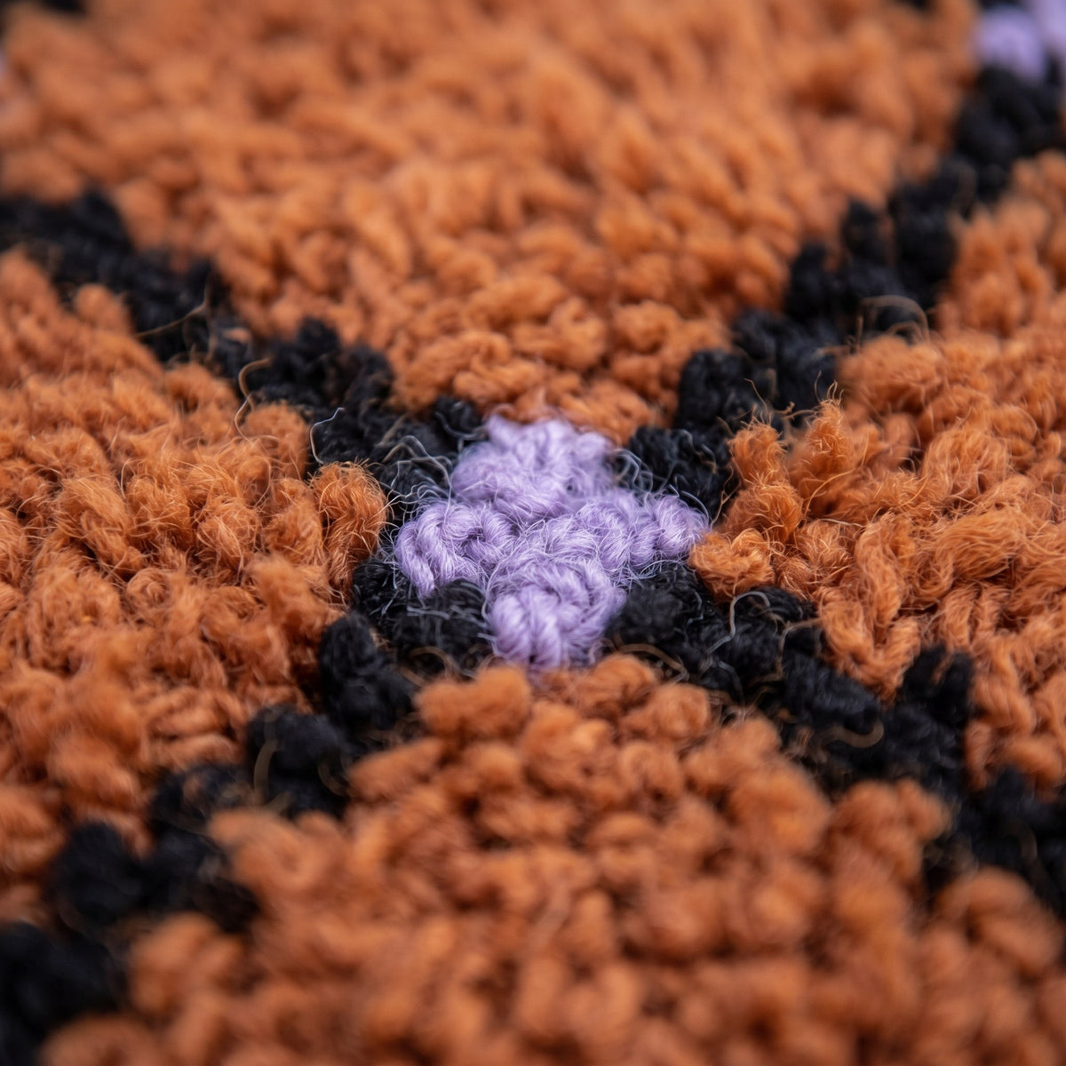 Close-up of a motif on the Tirfalt Berber rug, regular grid of outlined terracotta squares