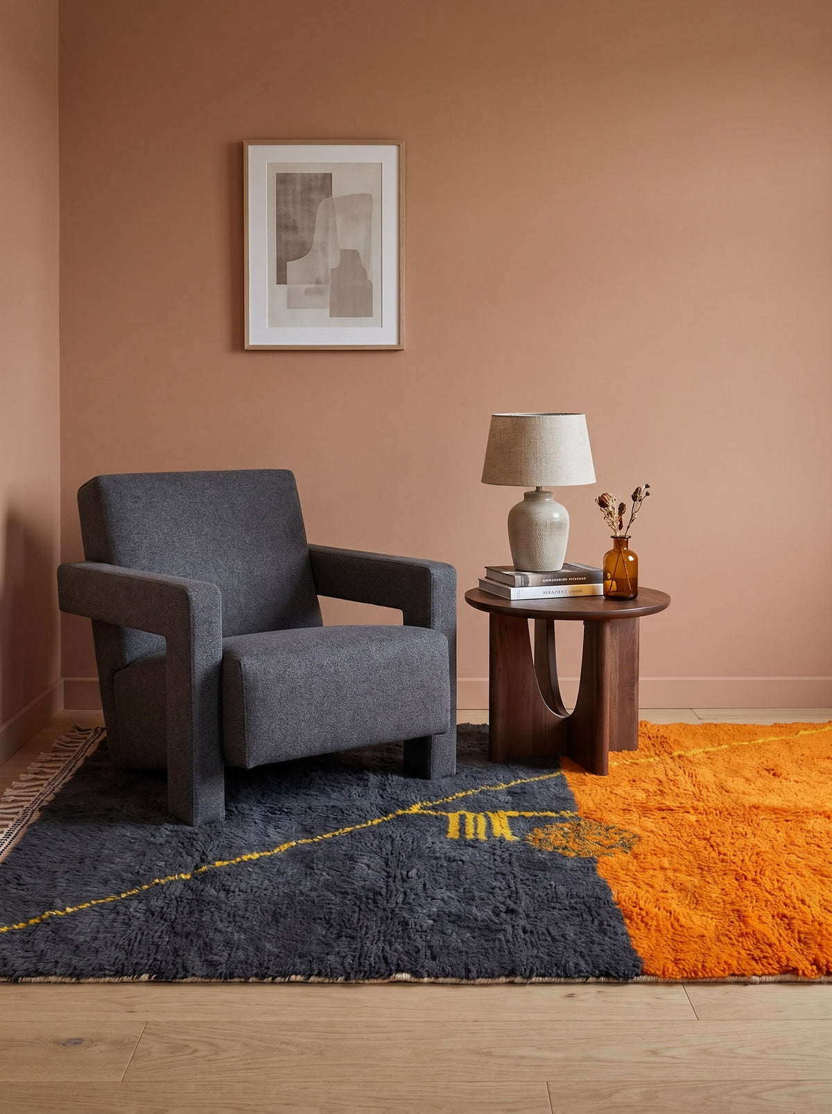 Fezouata graphic Berber rug in charcoal and orange in a reading nook, hand-knotted in Morocco