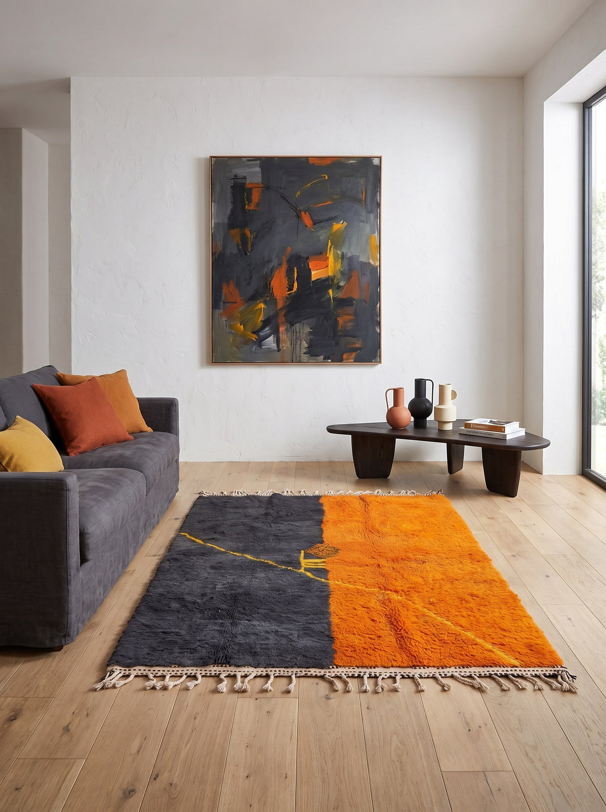 Fezouata graphic Berber rug in charcoal and orange in another living room, hand-knotted in Morocco