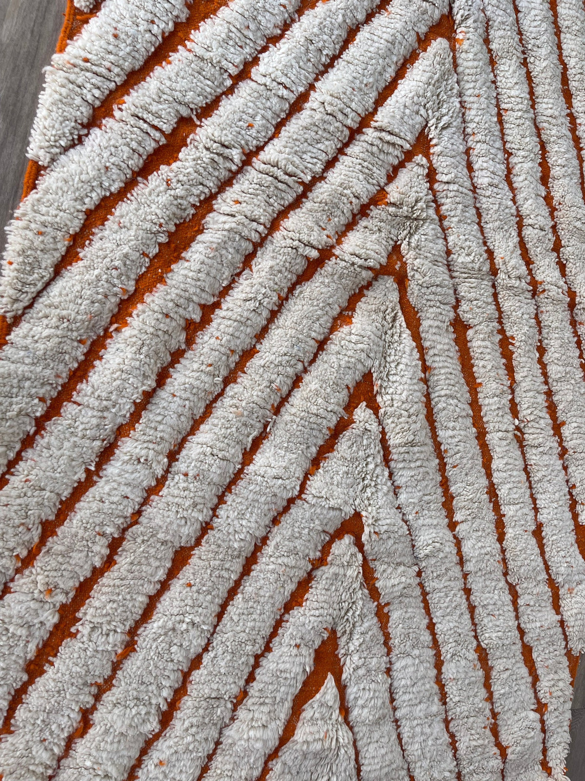 Close-up of a detail on the Igdat Berber rug, shades of the wool and pattern up close