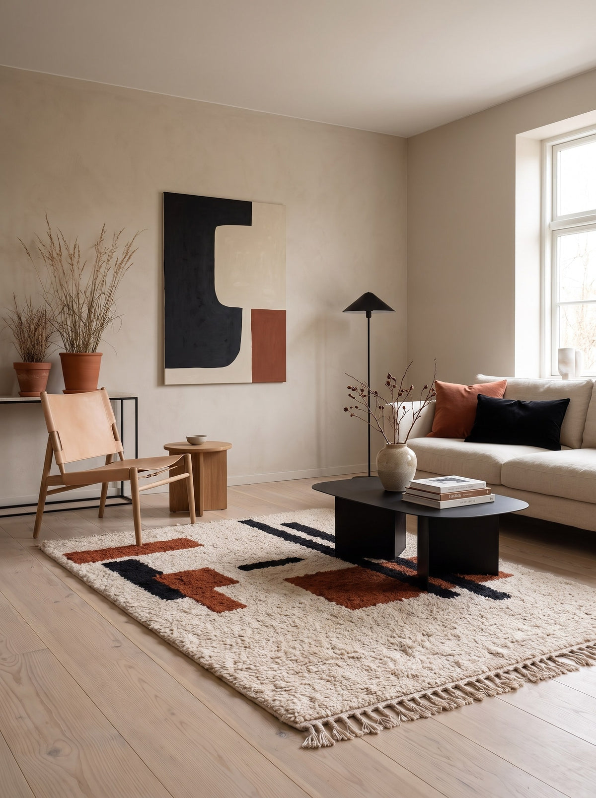 Meskala graphic Berber rug in white and terracotta, in a living room, hand-knotted in Morocco