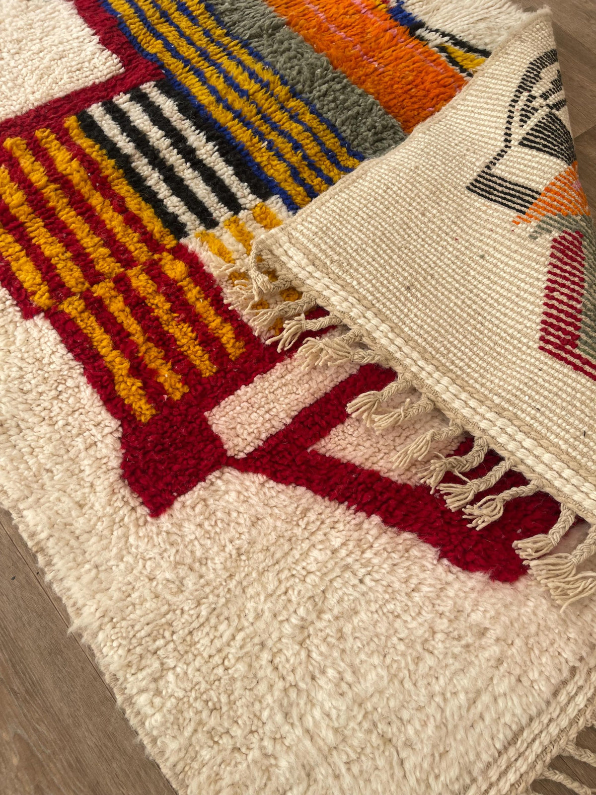 Close-up of the turned-up corner of the Tamgrout Berber rug, medium pile depth and hand-woven back