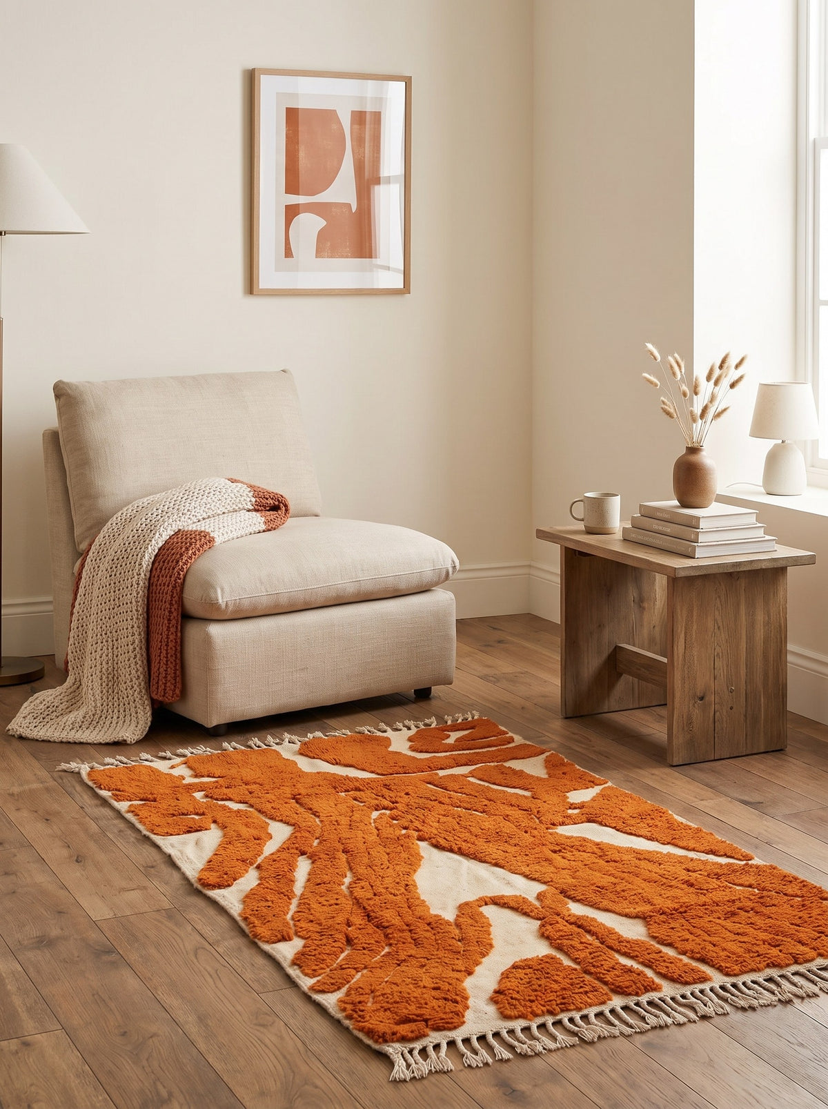 Chebbi graphic Berber rug in orange and white in a reading nook, hand-knotted in Morocco