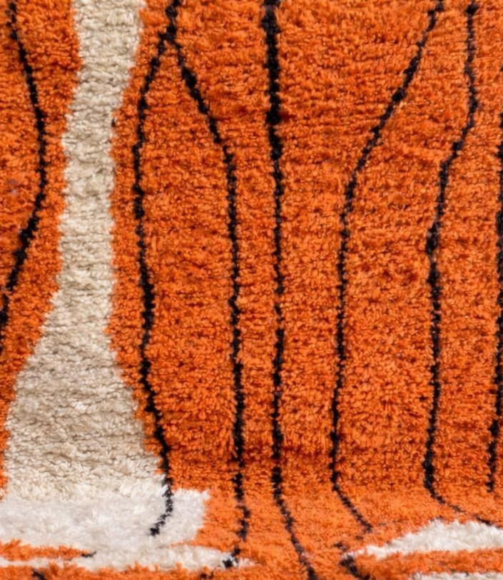 Close-up of the wool of the Sourzan Berber rug, sheep's wool with a long pile, orange
