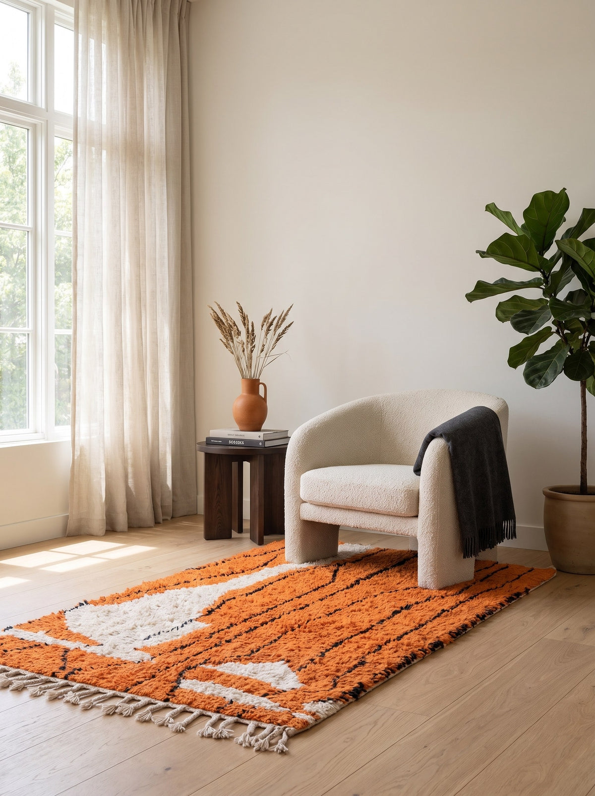 Sourzan graphic Berber rug in orange in a reading nook, hand-knotted in Morocco
