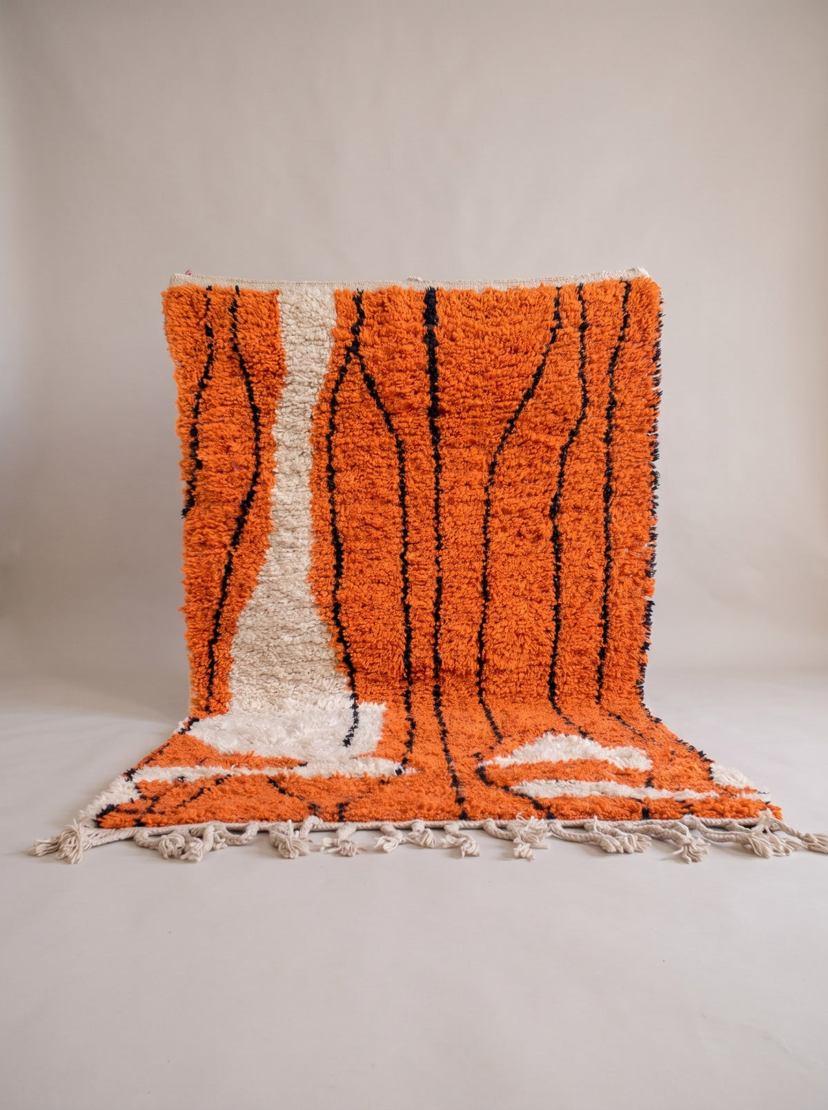 Sourzan graphic Berber rug in orange, hanging, one of a kind, hand-knotted in Morocco
