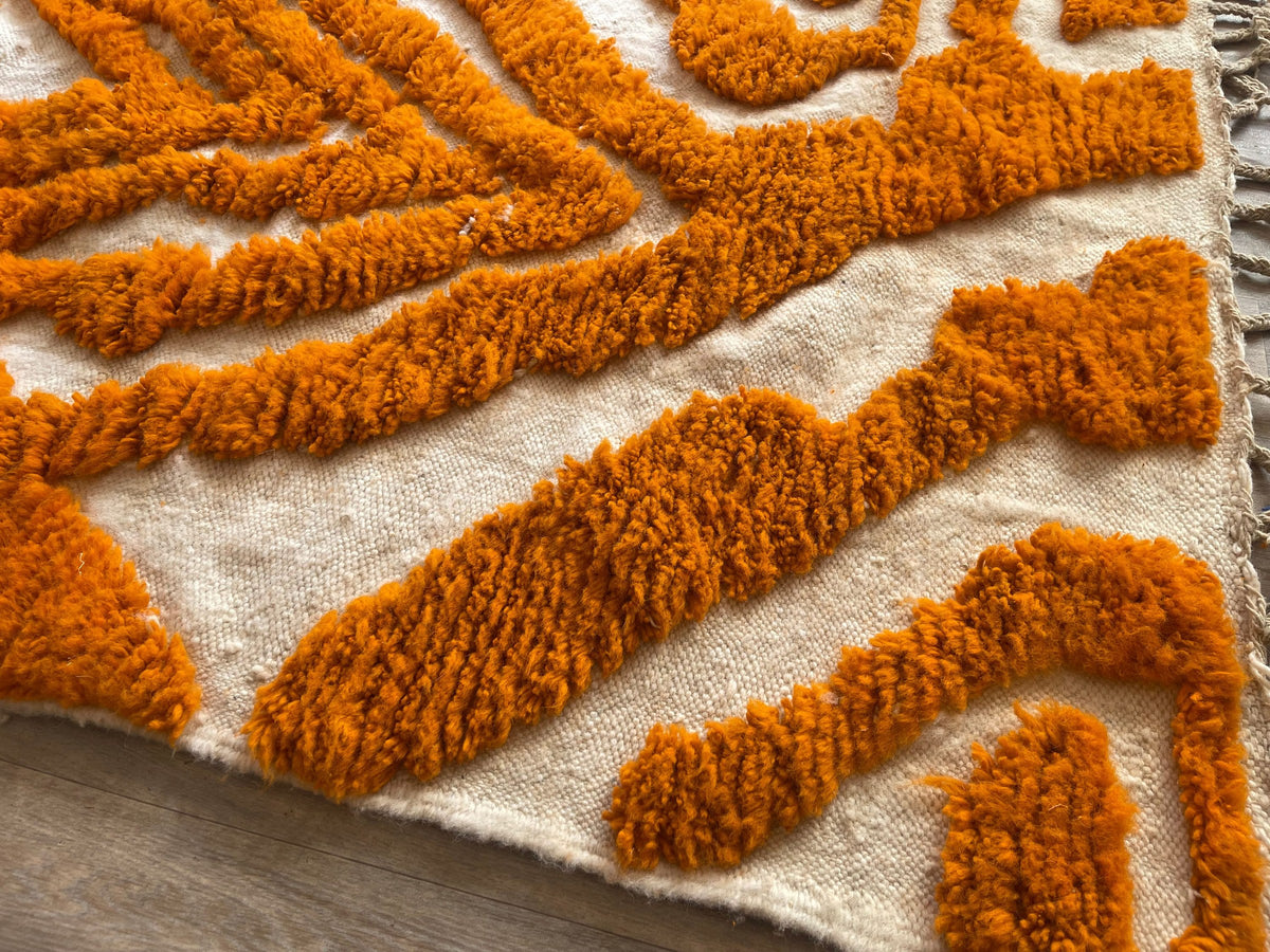 Close-up of the turned-up corner of the Tazemurt Berber rug, thick long pile and hand-woven back
