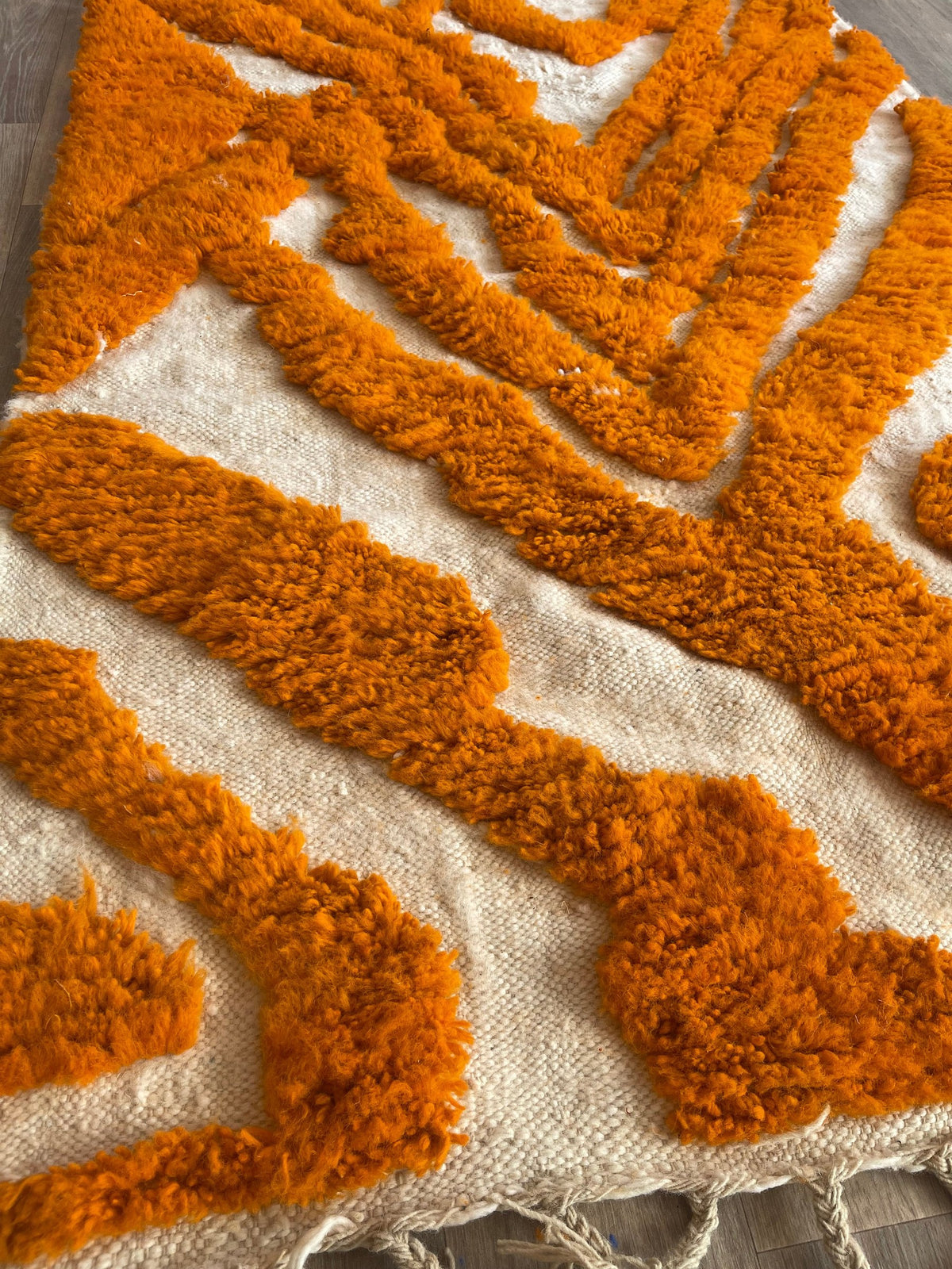 Close-up of a detail of the Tazemurt Berber rug, long pile and orange motif up close