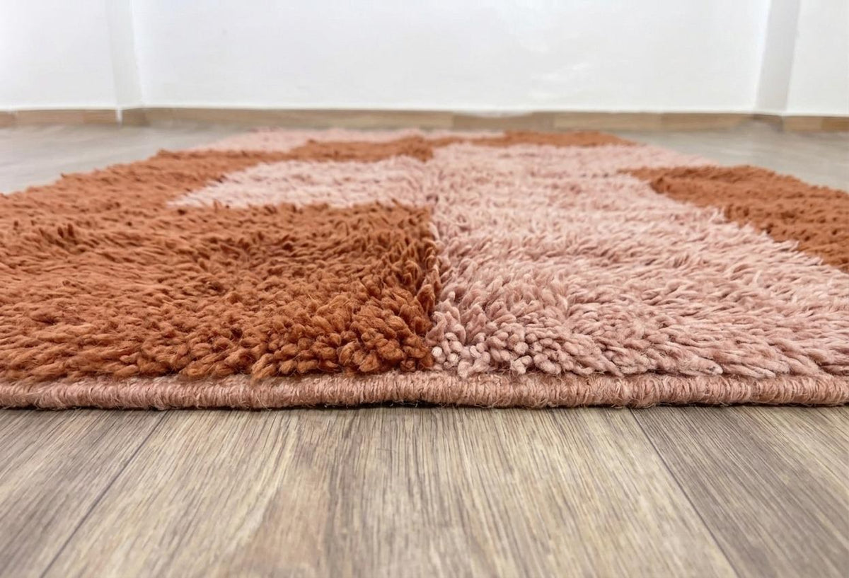 Close-up of the turned-up corner of the Tarmizt Berber rug, thickness of the long pile and hand-woven back