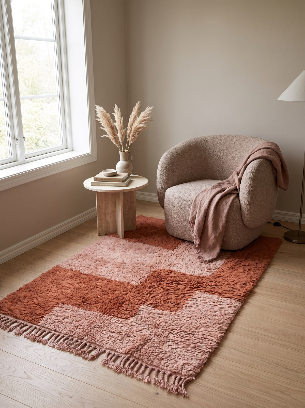 Tarmizt graphic Berber rug in terracotta and pink in a reading nook, hand-knotted in Morocco