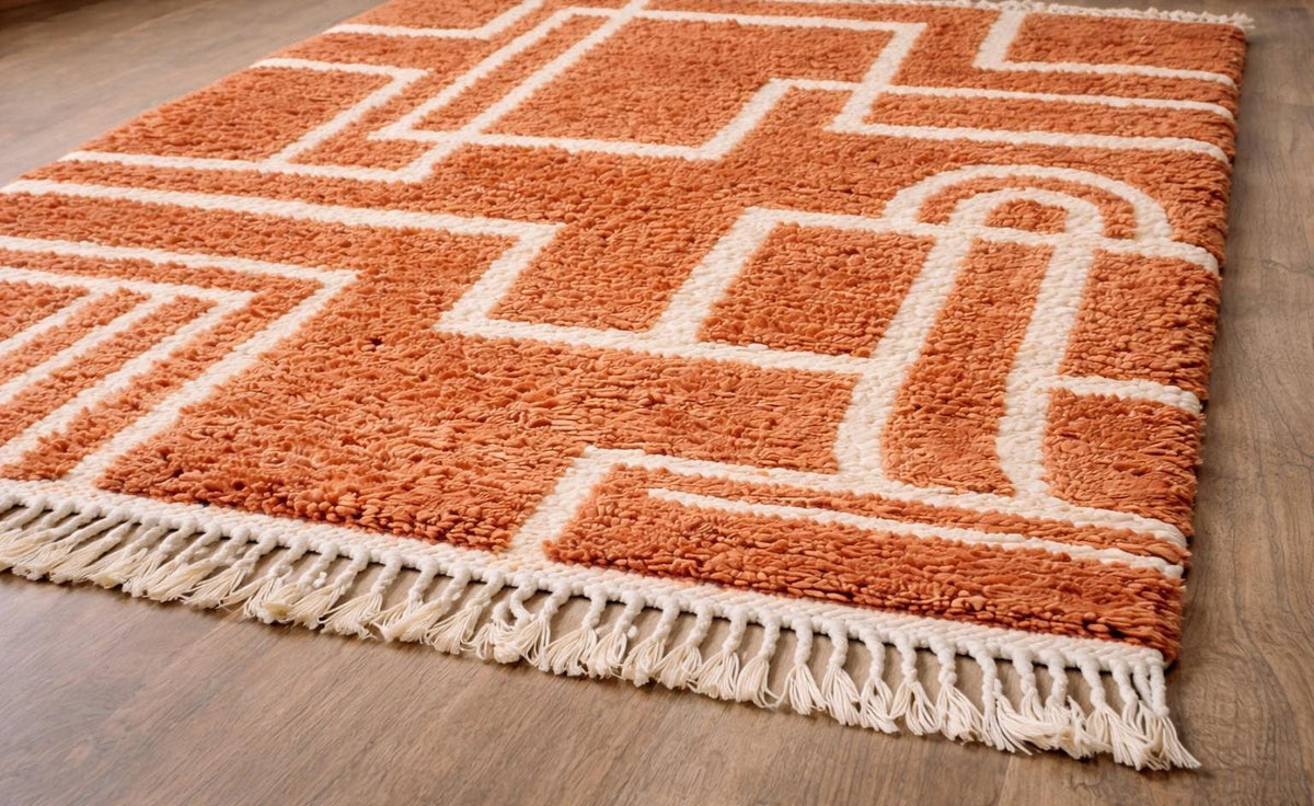 Khorbat graphic Berber rug in terracotta, on the floor, seen from the side at an angle, hand-knotted in Morocco