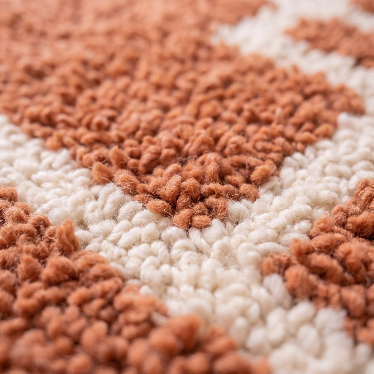 Close-up of a motif on the Khorbat Berber rug, terracotta ground, wide ecru lines forming a maze