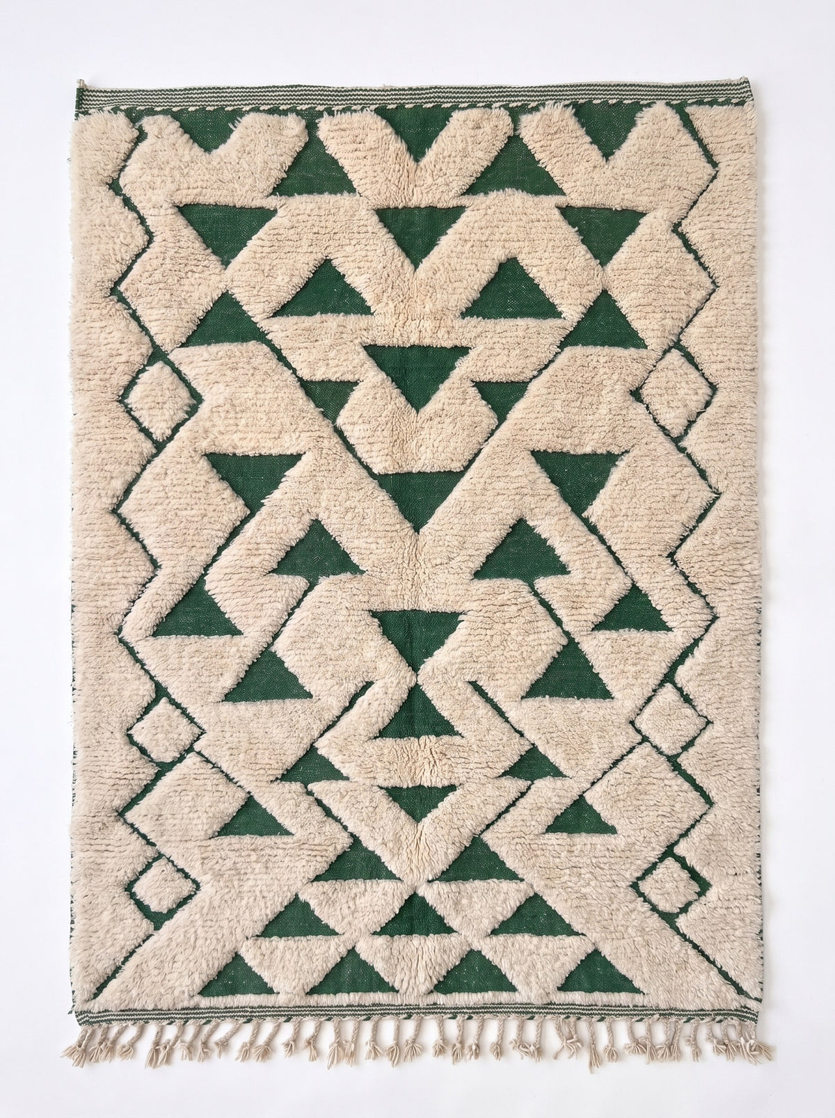 Tapis berbère graphique vert et blanc Sezlan vu à plat, zigzags emboîtés laissant sept rangées de triangles verts pointe