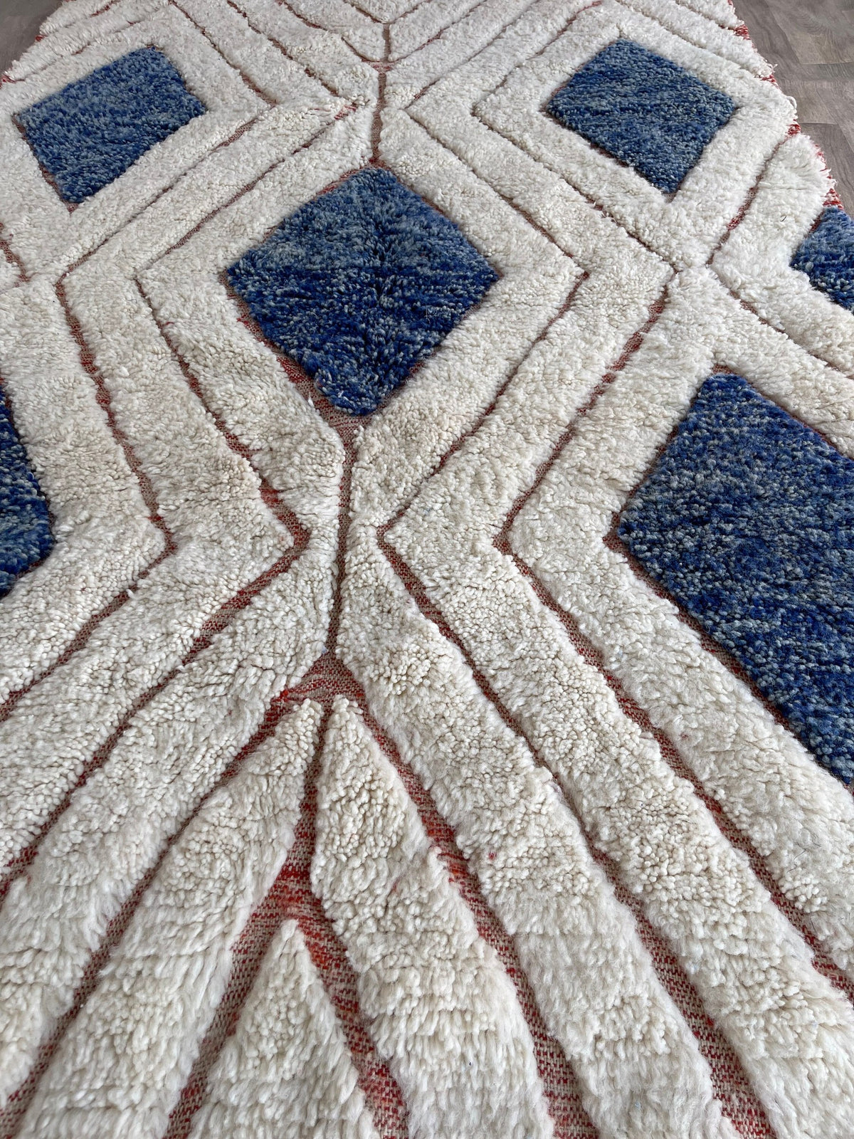 Gros plan sur un détail du tapis berbère Aman, tracé irrégulier du motif fait main