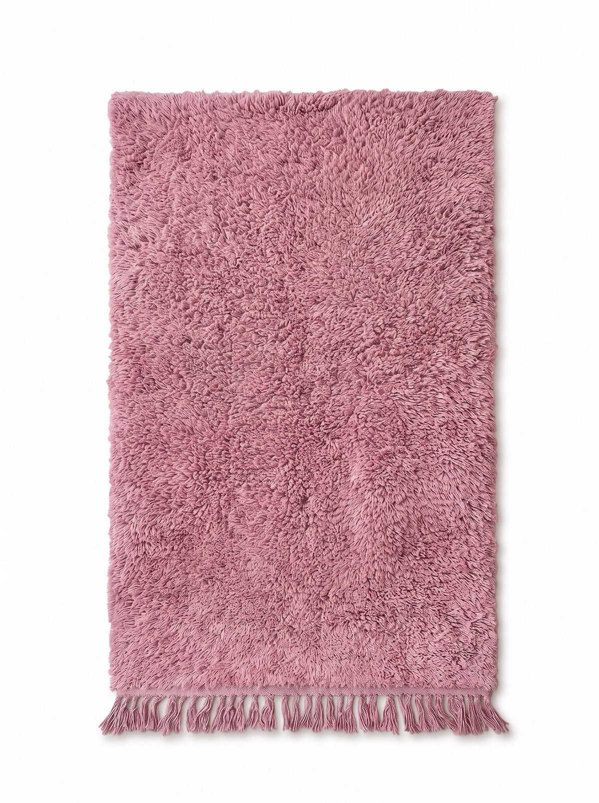 Tapis berbère uni rose Tanirt vu à plat, rose poudré uni sur toute la surface, franges rose assorties nouées en bas seulement