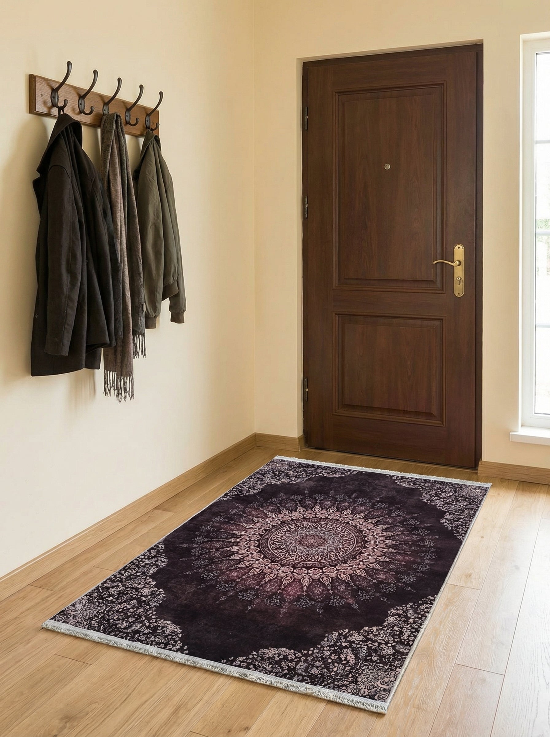 Tapis rectangulaire violet foncé à motifs floraux et médaillon central rose pâle, posé sur parquet dans une entrée