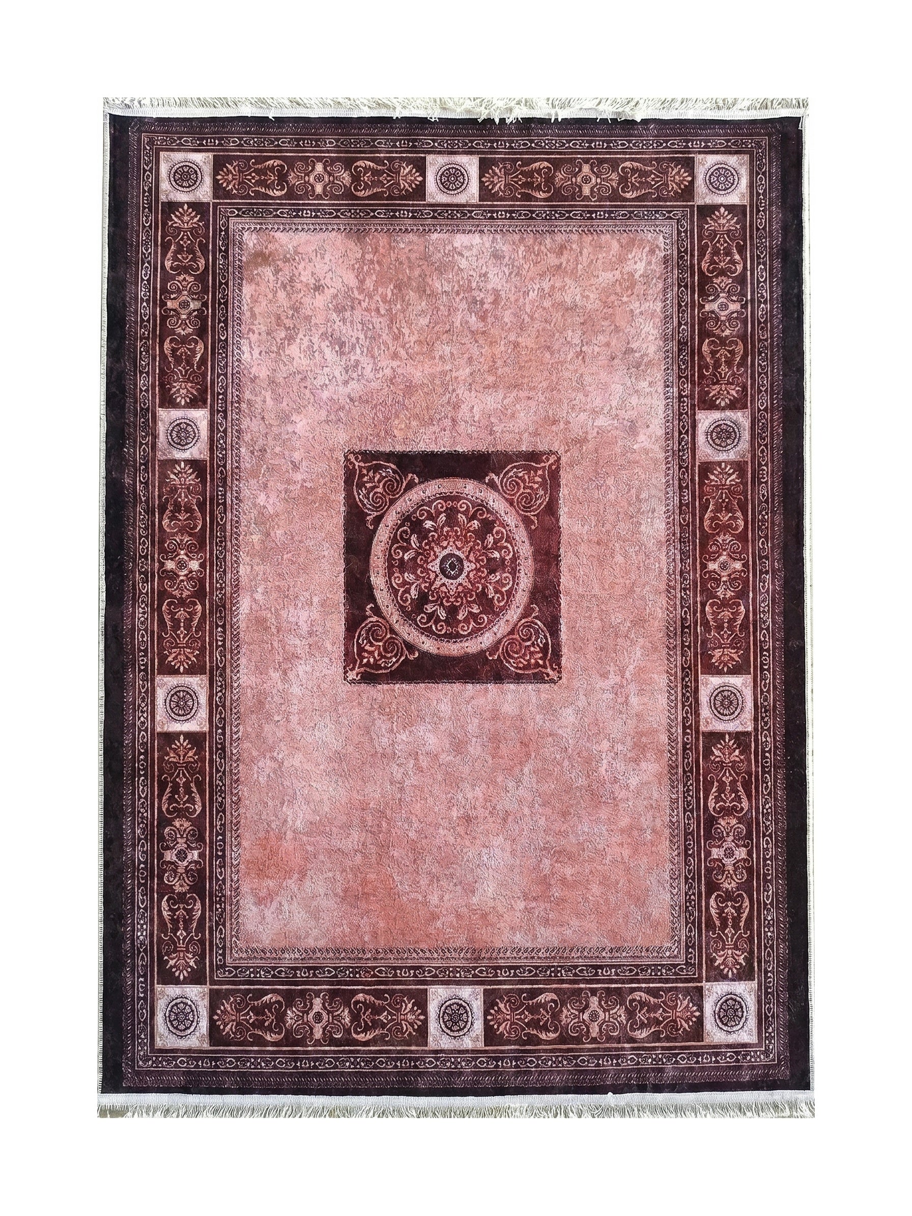 Tapis rectangulaire rose poudré et marron foncé. Son centre texturé affiche un médaillon sombre, encadré de bordures ornementales et de franges claires