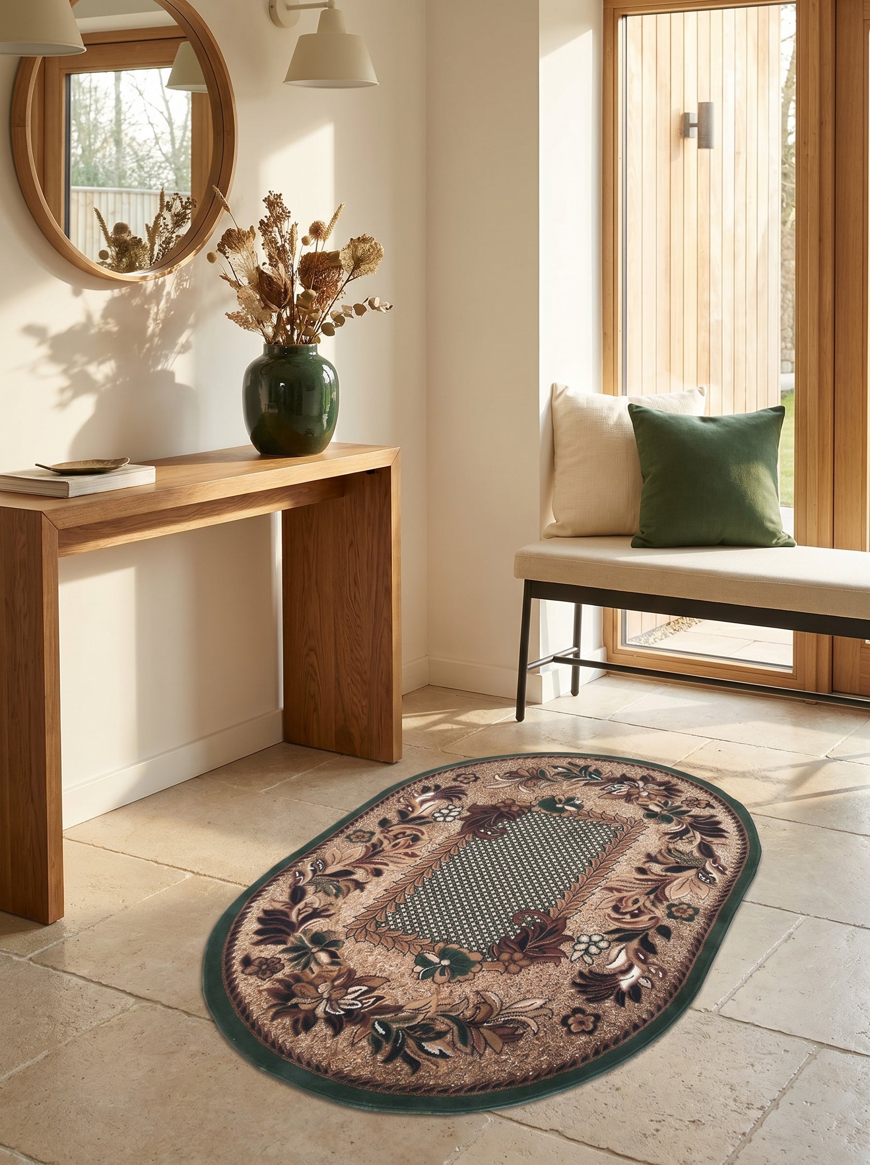 Tapis ovale beige et marron à motifs floraux et géométriques verts, bordé de vert foncé, posé sur un sol carrelé dans une entrée lumineuse
