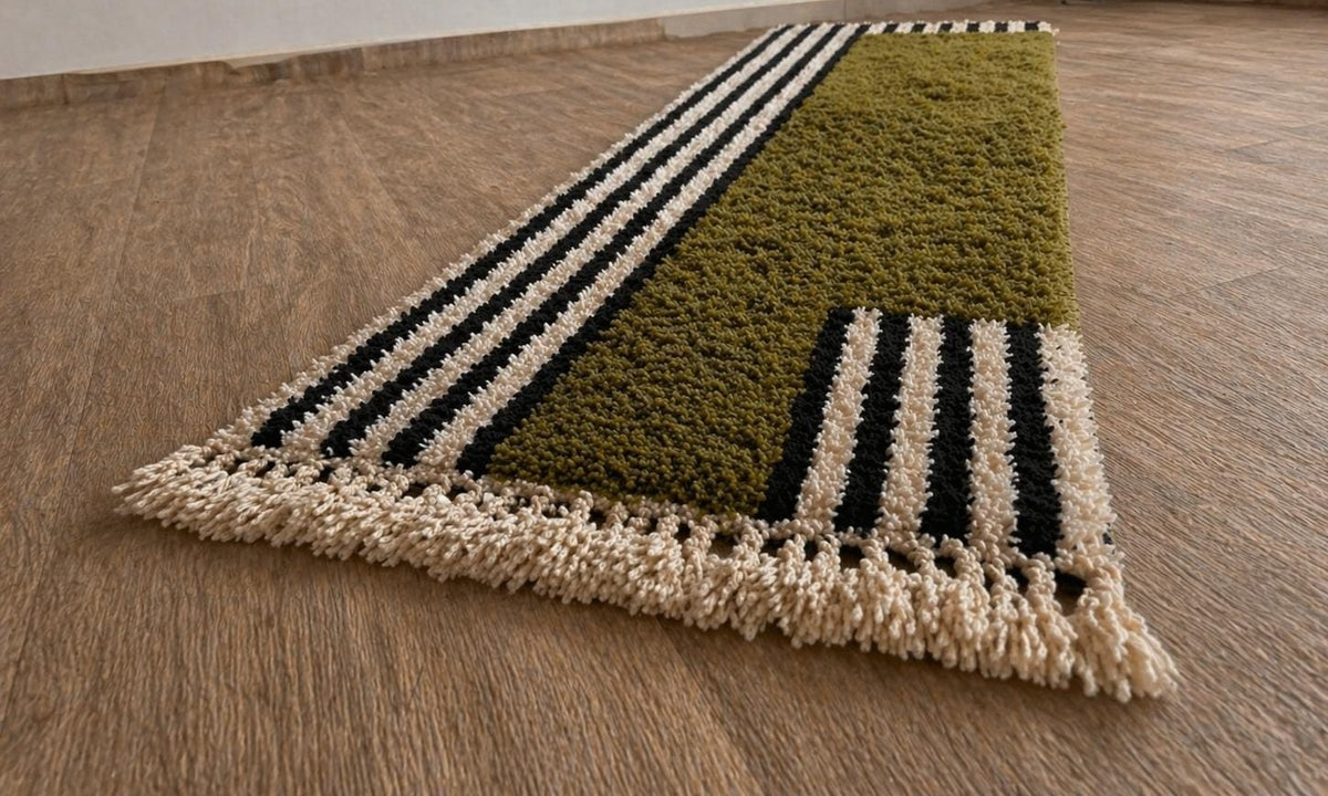Tanuwar Berber stair runner, striped, in olive green, on the floor, seen at an angle, hand-knotted in Morocco