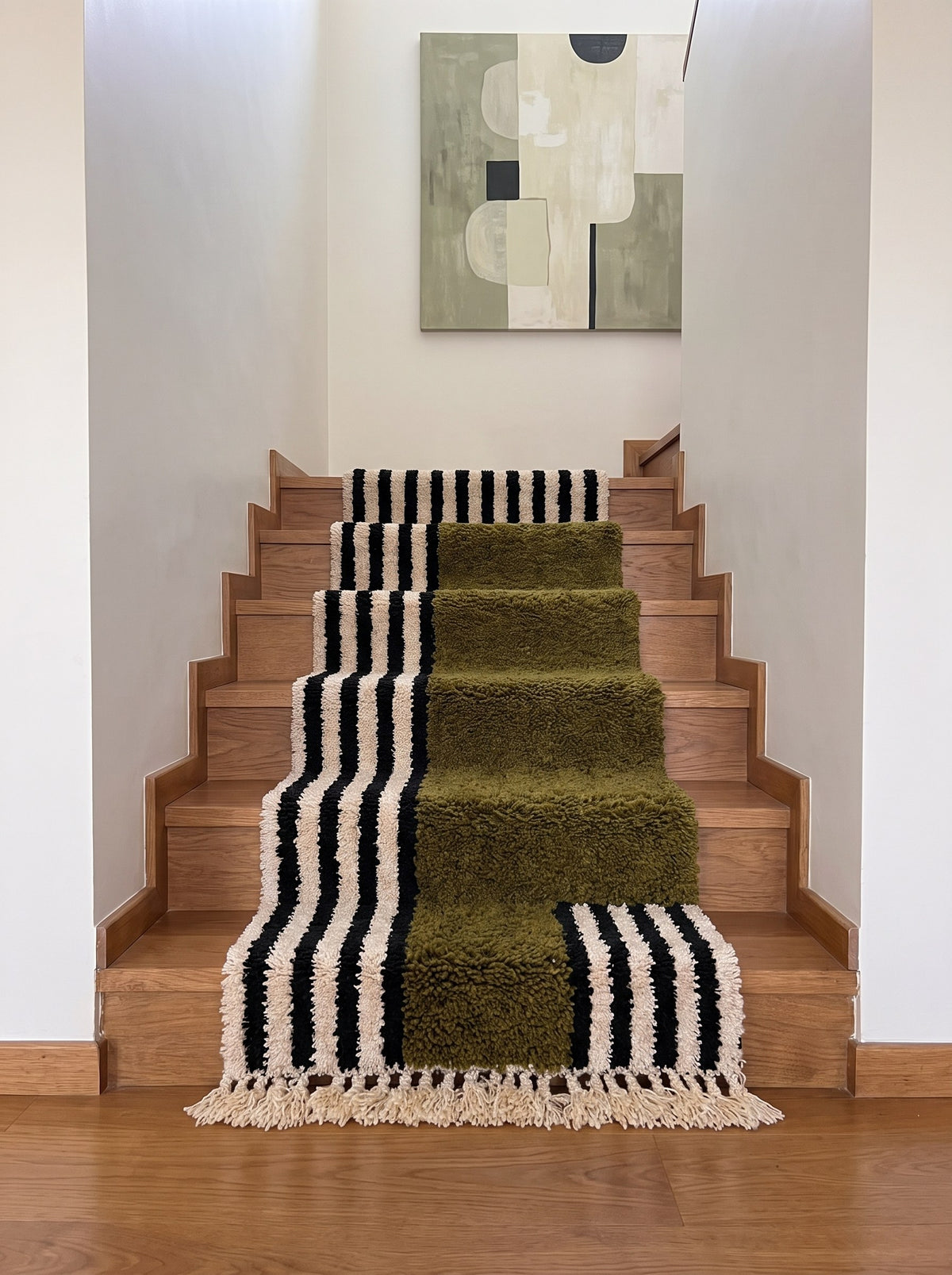 Tanuwar Berber stair runner with olive green stripes on a staircase, hand-knotted in Morocco
