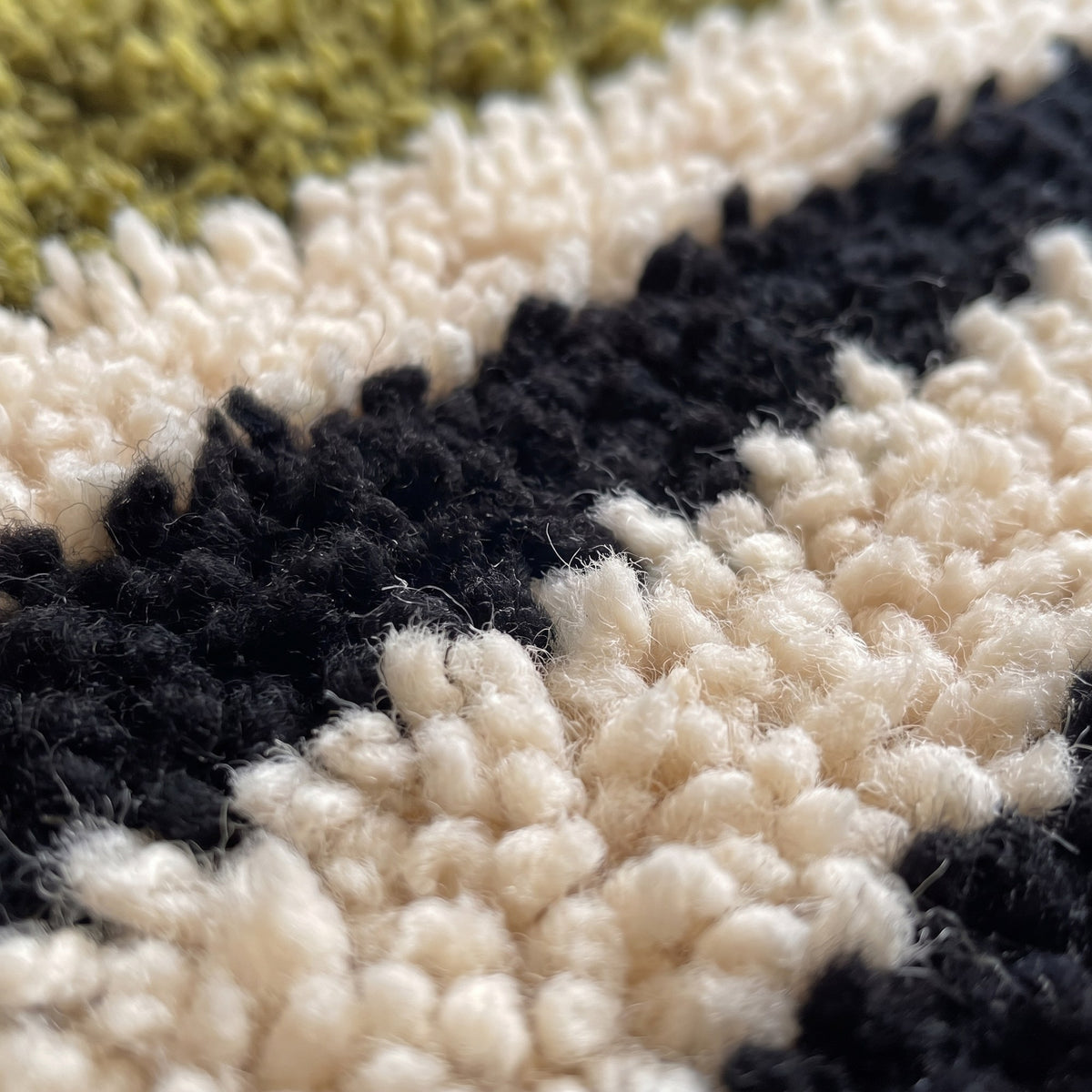 Close-up of a motif on the Tanuwar Berber stair runner, four black stripes alternating along the runner
