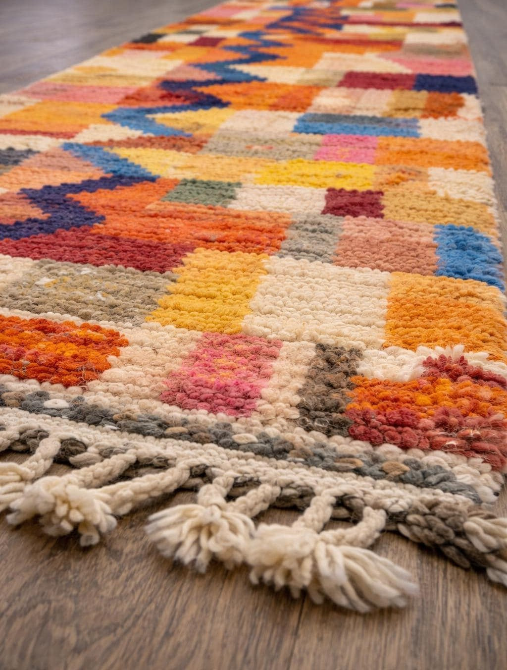 Anzarane Berber stair runner, colourful, in orange and blue, on the floor, seen from the side, hand-knotted in Morocco