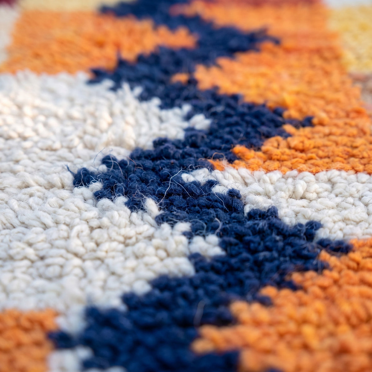 Close-up of a motif on the Anzarane Berber stair runner, patchwork runner of small orange blocks