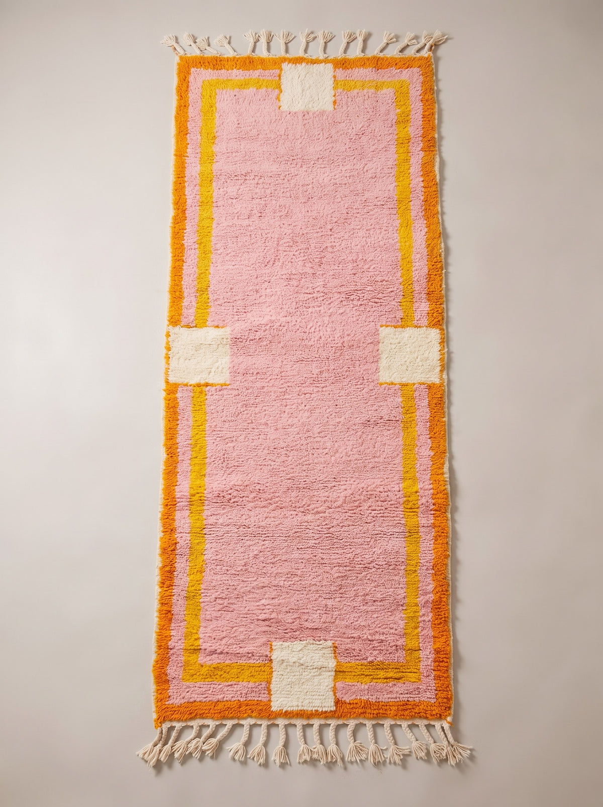 Berkane colourful Berber stair runner in pink, laid flat, powder pink, double orange and yellow border, ecru fringes