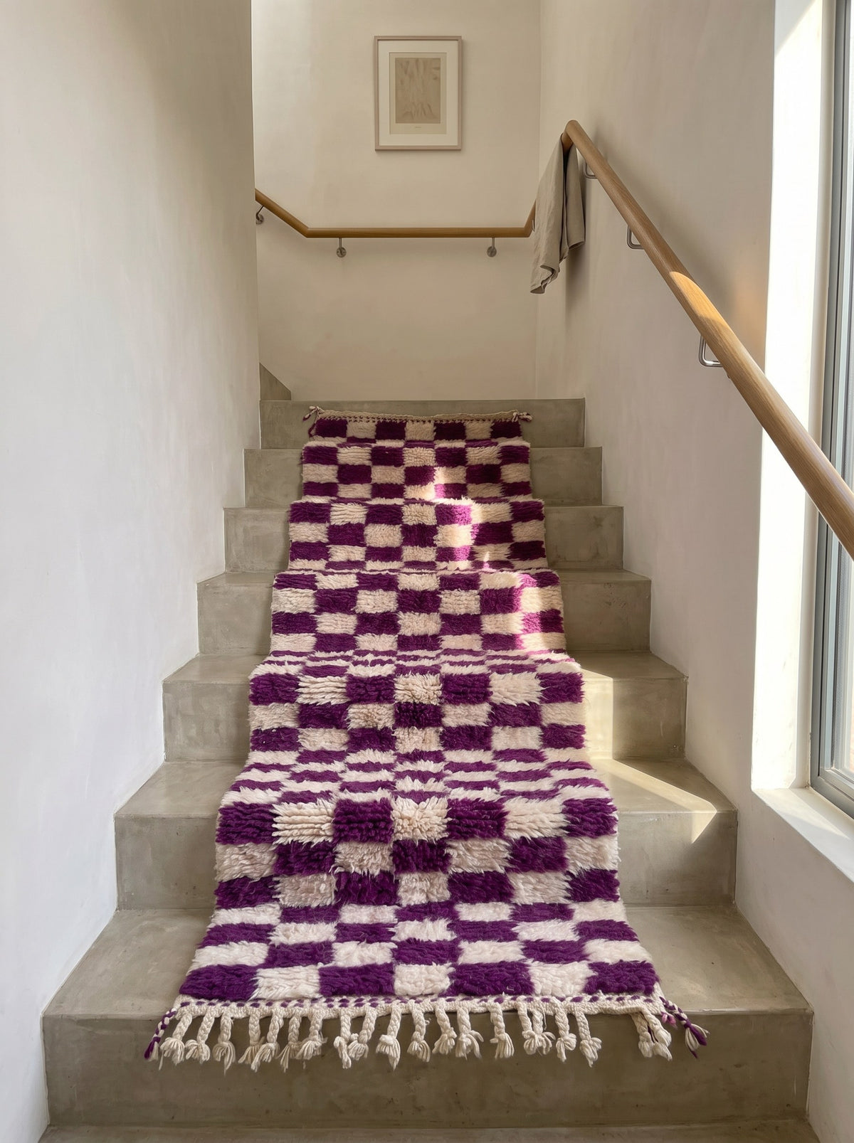 Zerrouka Berber stair runner with a purple checkerboard pattern, on a third staircase, hand-knotted in Morocco