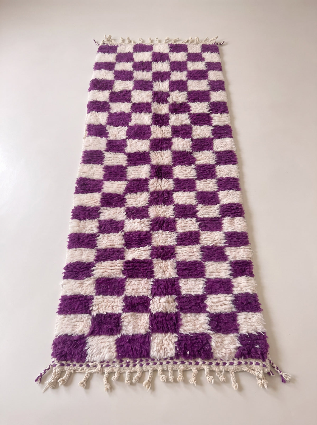 Zerrouka Berber stair runner, chequered, in purple, laid flat, runner with long dense pile, regular purple and ecru chequerboard