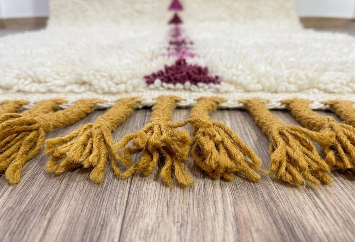 Gros plan sur les franges du tapis d'escalier berbère Anir, moutarde torsadées, nouées à la main