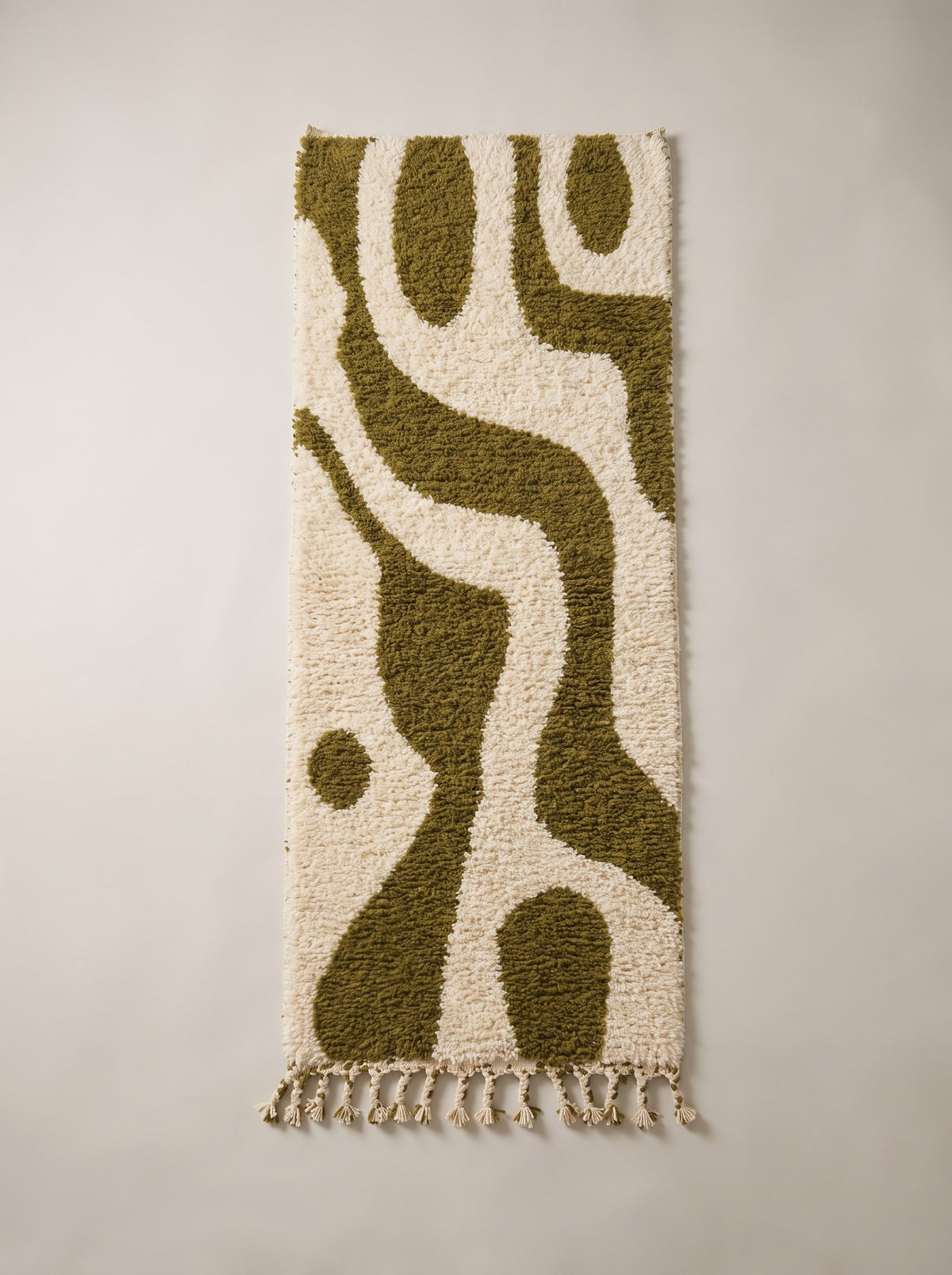 Assaka Berber stair runner, graphic, in white and olive green, laid flat, ecru ground, wide olive green wave winding from the top
