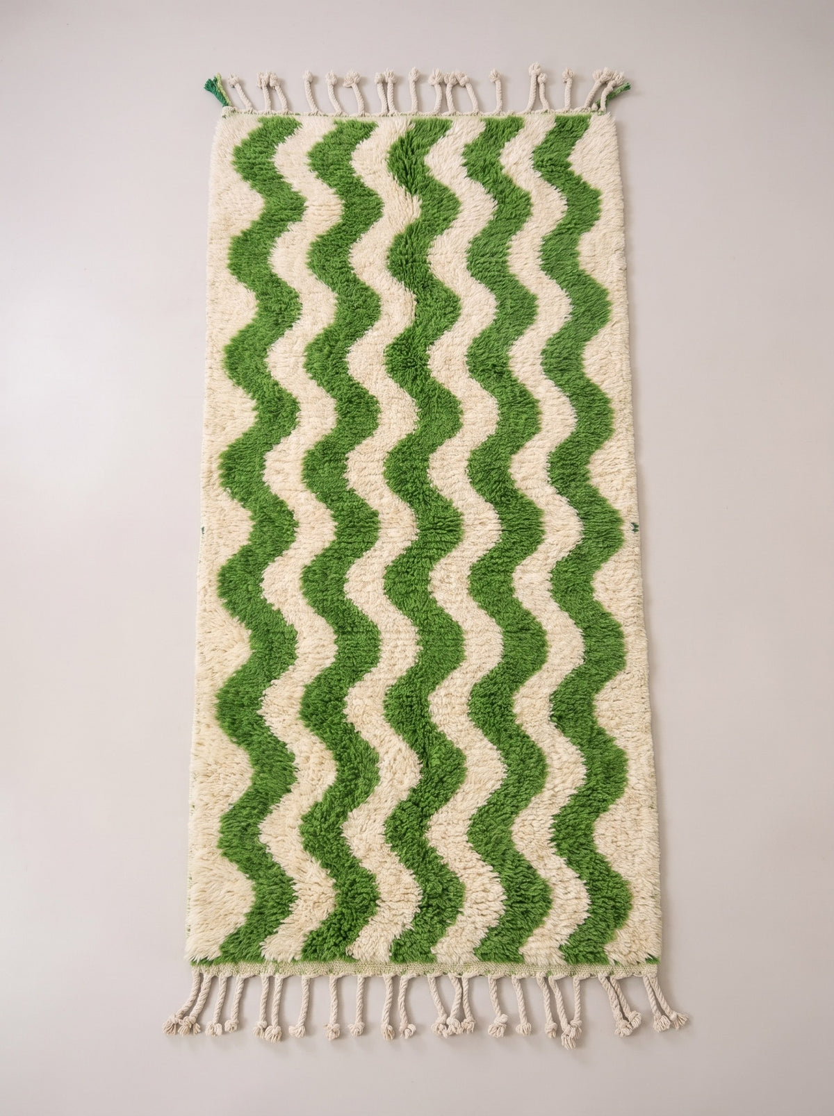 Ouzoud Berber stair runner, graphic, in green and white, laid flat, long pile, ecru ground, five vertical bright green waves