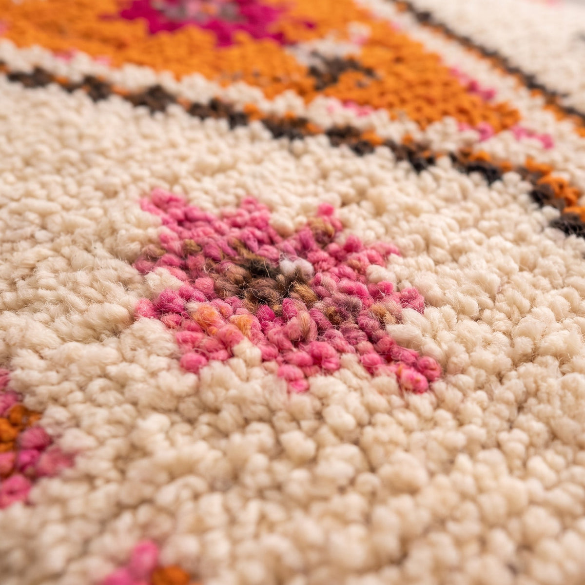 Close-up of a motif on the Tifawin Berber stair runner, ecru runner, an orange diamond on the centre line
