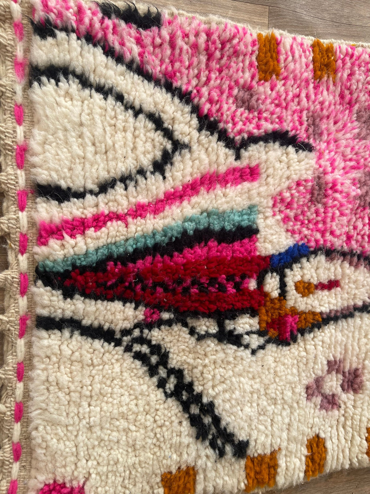 Close-up of the turned-up corner of the Ameln Berber stair runner, medium pile depth and hand-woven back