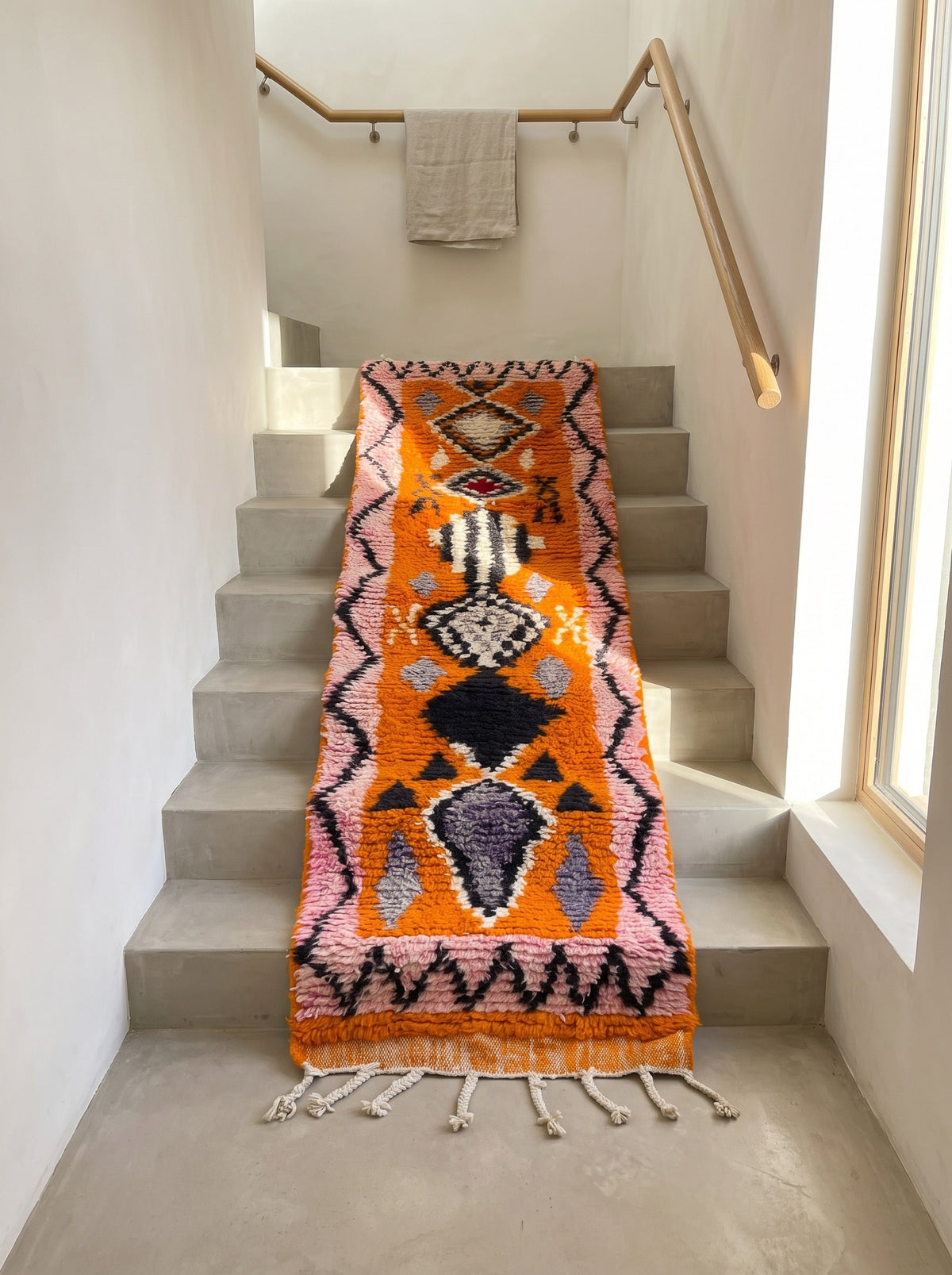 Khamlia Berber stair runner, Boujad style, in orange and pink, on a third staircase, hand-knotted in Morocco